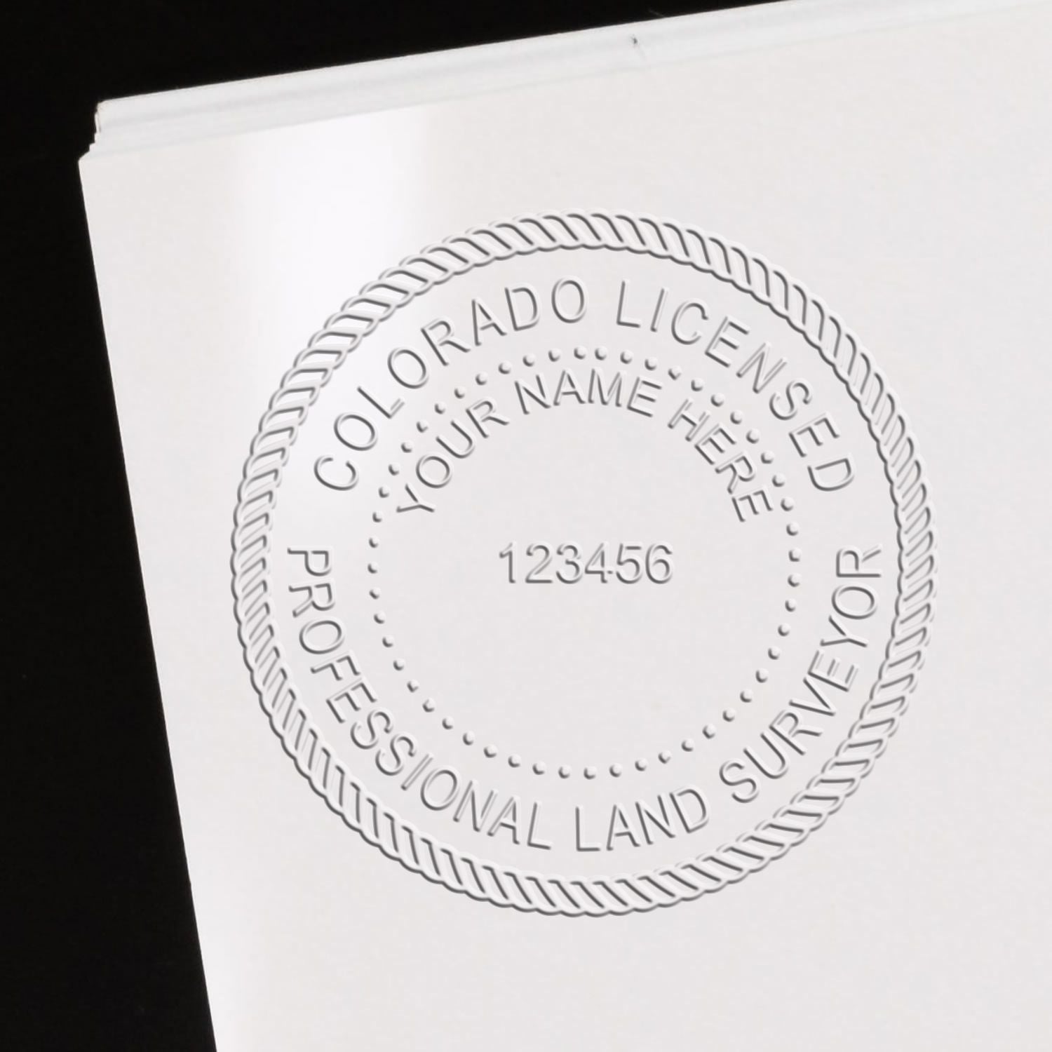 The main image for the Colorado Desk Surveyor Seal Embosser depicting a sample of the imprint and electronic files