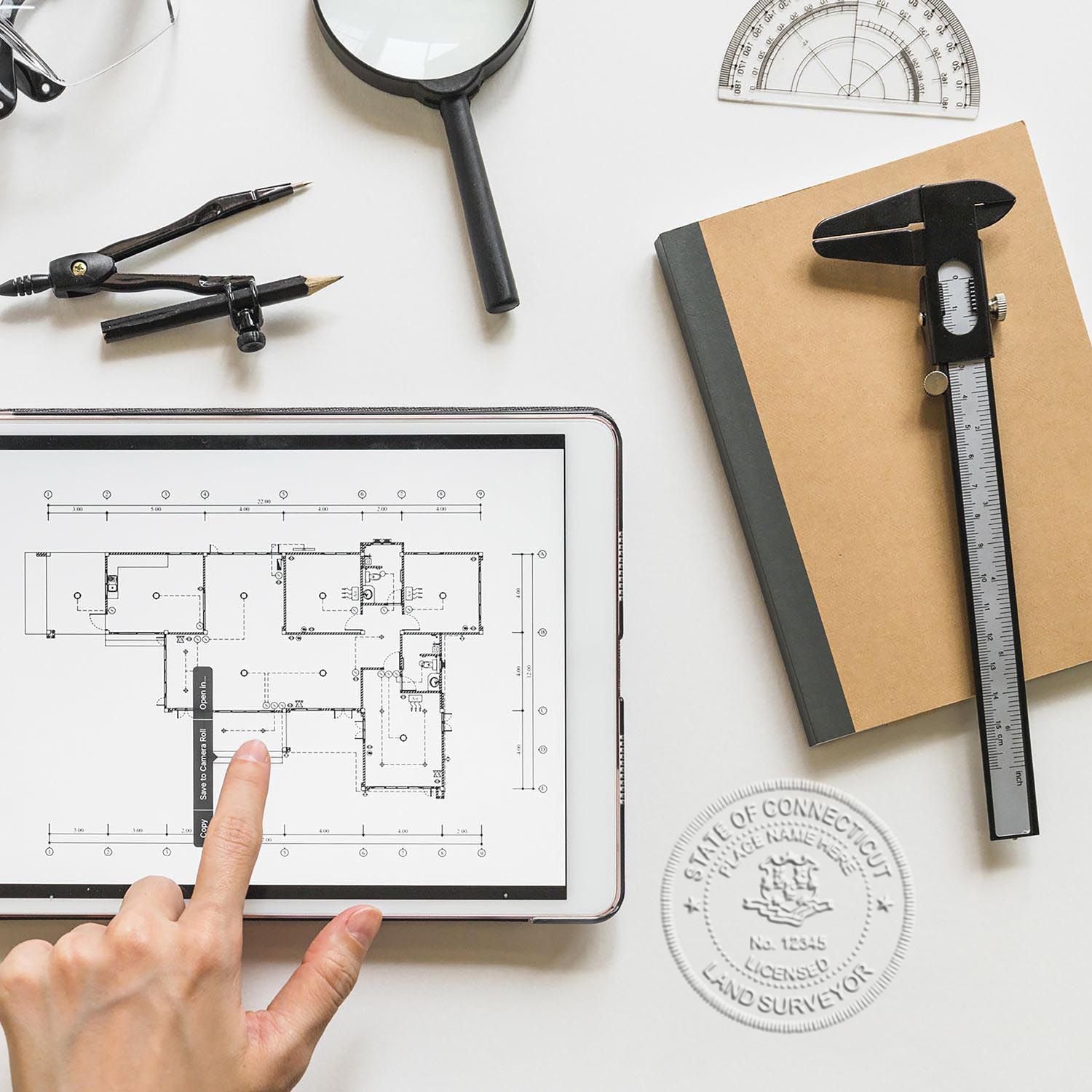A stamped impression of the Heavy Duty Cast Iron Connecticut Land Surveyor Seal Embosser in this stylish lifestyle photo, setting the tone for a unique and personalized product.