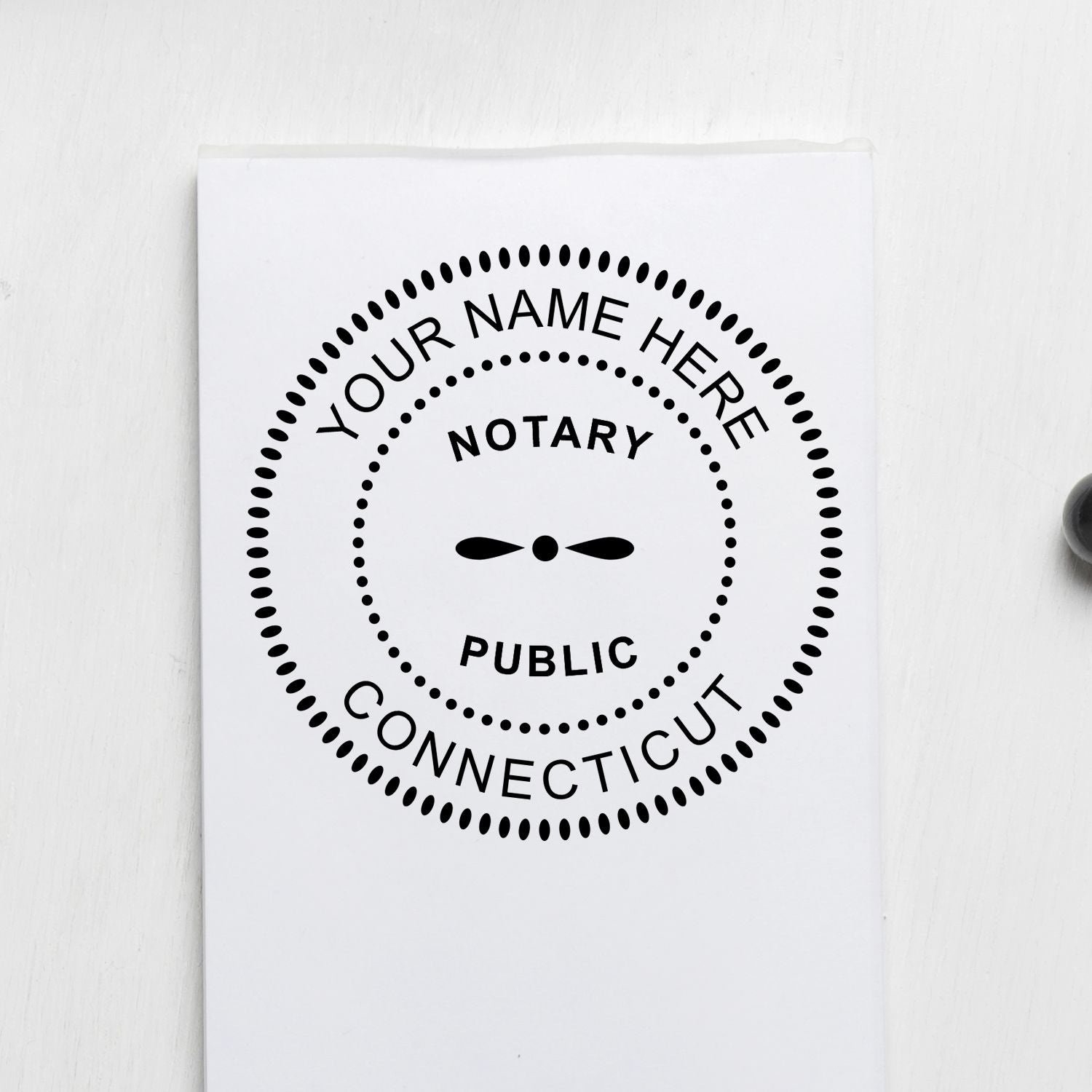 An alternative view of the Slim Pre-Inked Round Notary Stamp for Connecticut stamped on a sheet of paper showing the image in use