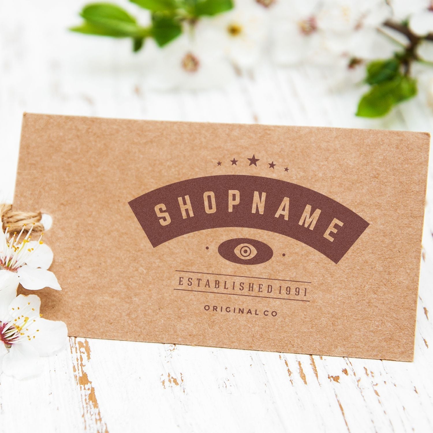 A Custom Self Inking Rubber Stamp Trodat 4914 Size 1 x 2-1/2 is used to stamp a brown card with SHOPNAME and decorative elements.