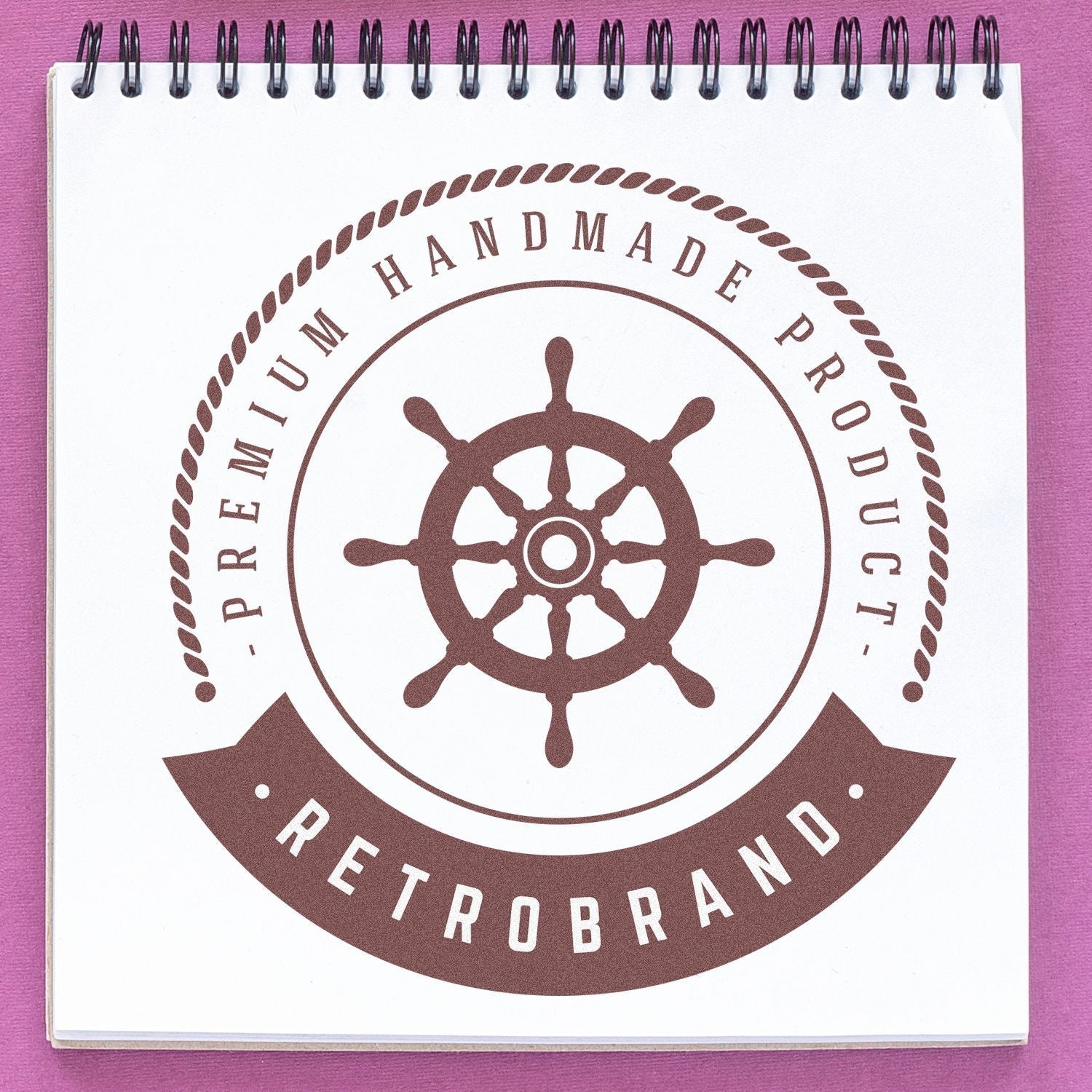 Custom Rubber Stamp Size 8 Inch Diameter used on a spiral notebook, displaying a nautical-themed Premium Handmade Product design with Retrobrand text.