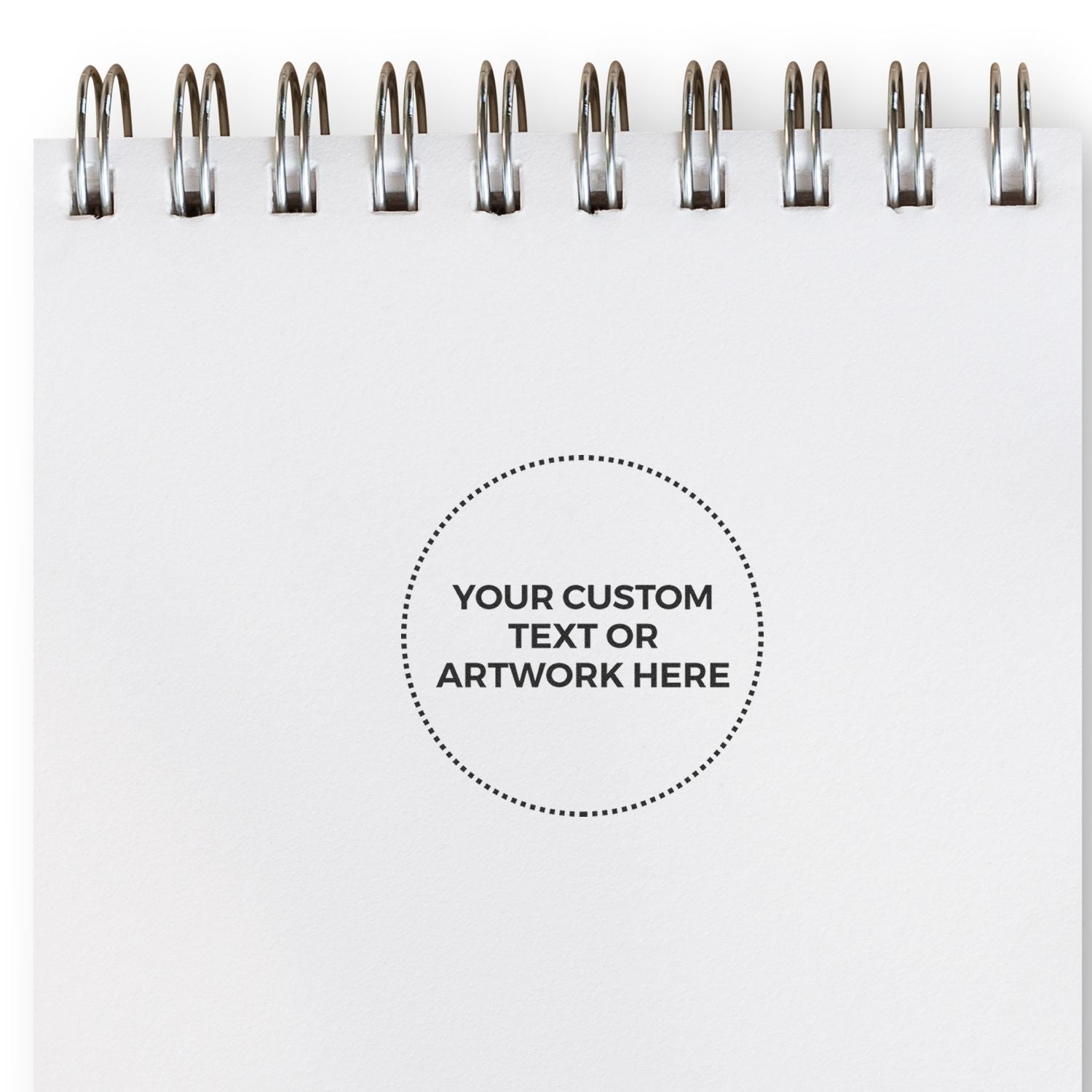 Custom Self Inking Stamp Trodat 4638 Size 1-1/2 Diameter imprint on a white notepad with spiral binding, showing Your Custom Text or Artwork Here .