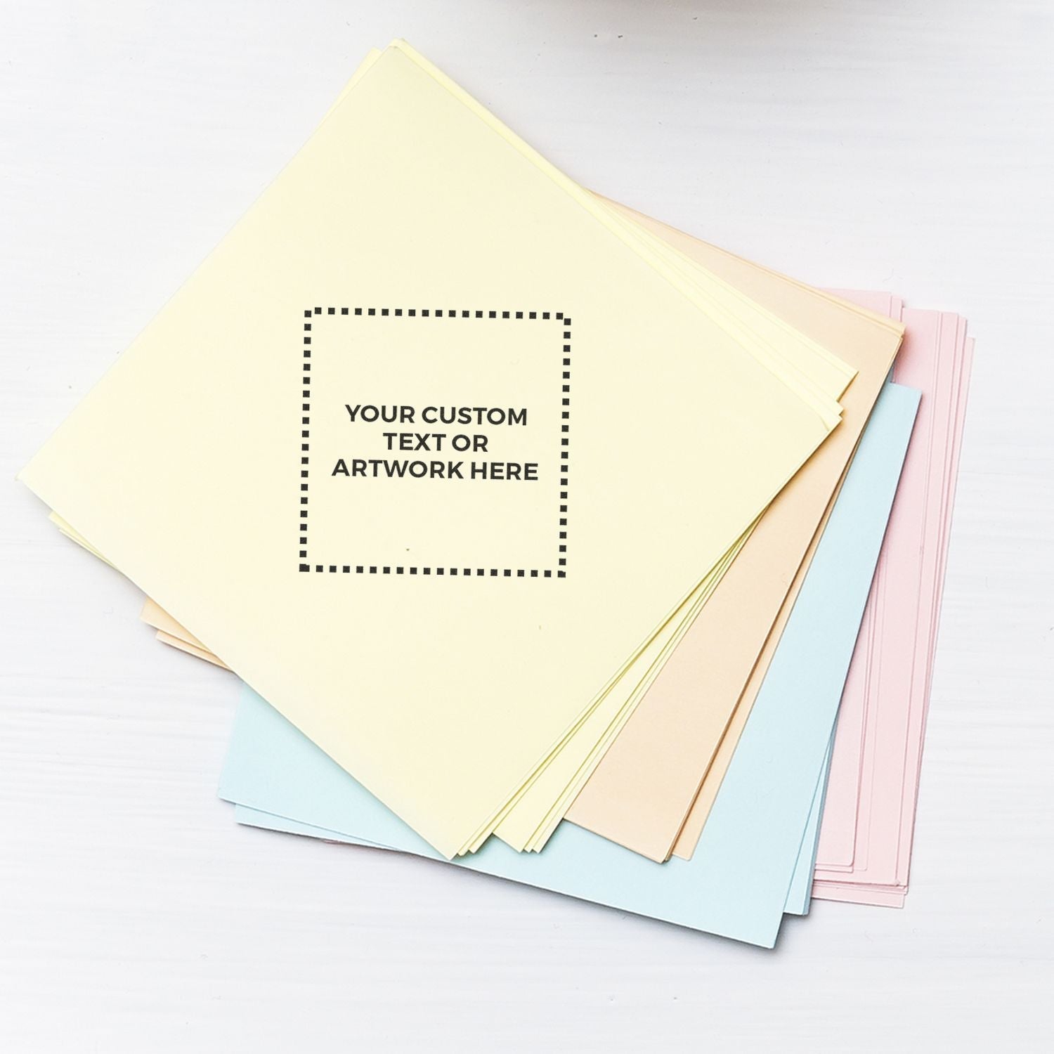 Custom Self Inking Stamp Trodat 4922 Size 13/16 x 13/16 displayed on a stack of pastel-colored papers with Your Custom Text or Artwork Here text.