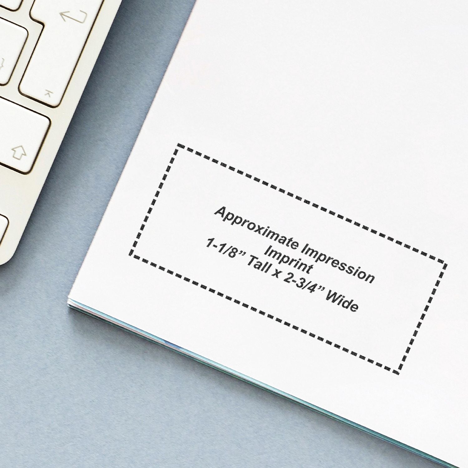 Jurat Notary Stamp impression on white paper, showing approximate imprint size of 1-1/8 tall x 2-3/4 wide, next to a keyboard.