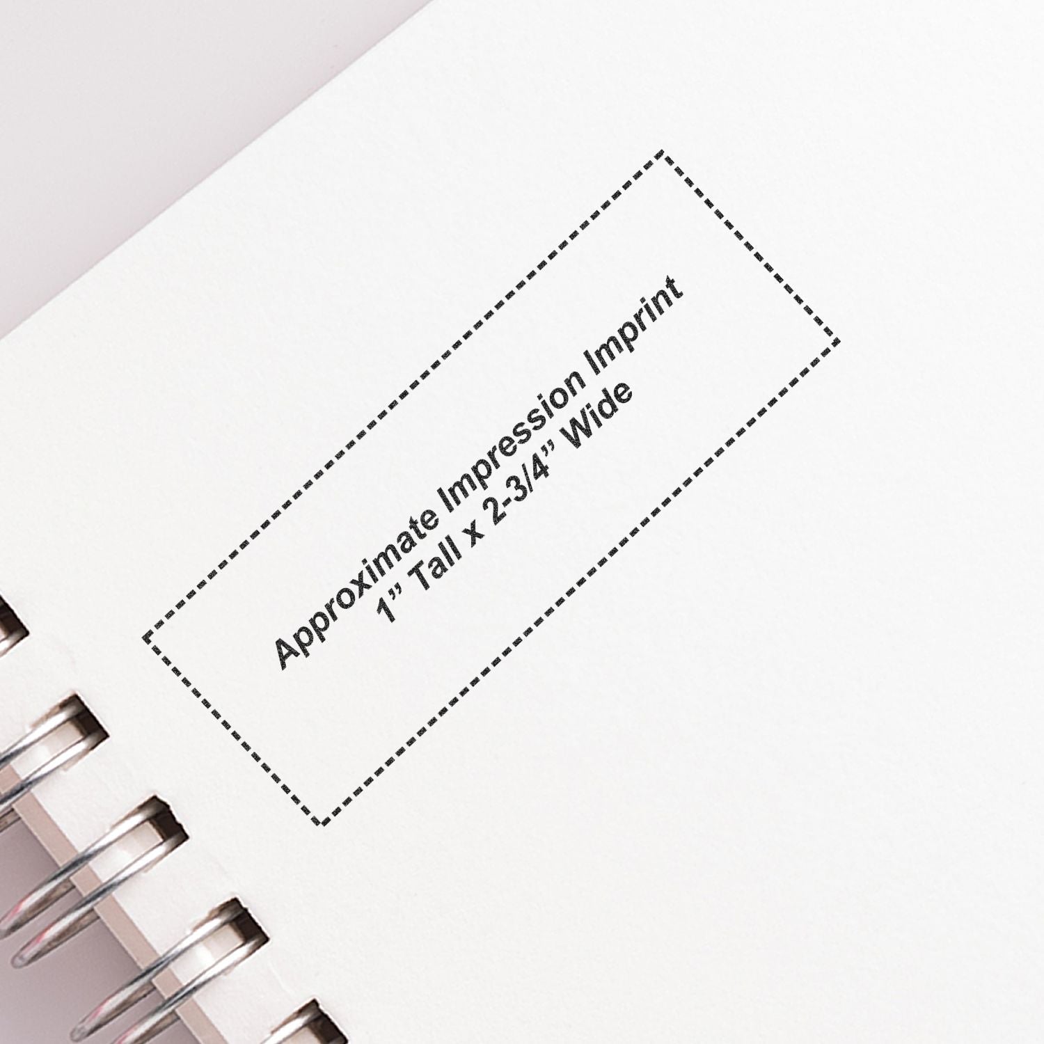 Custom Self Inking Stamp Trodat 5205 Size 1 x 2-3/4 imprint on white paper with spiral binding, showing approximate impression dimensions.