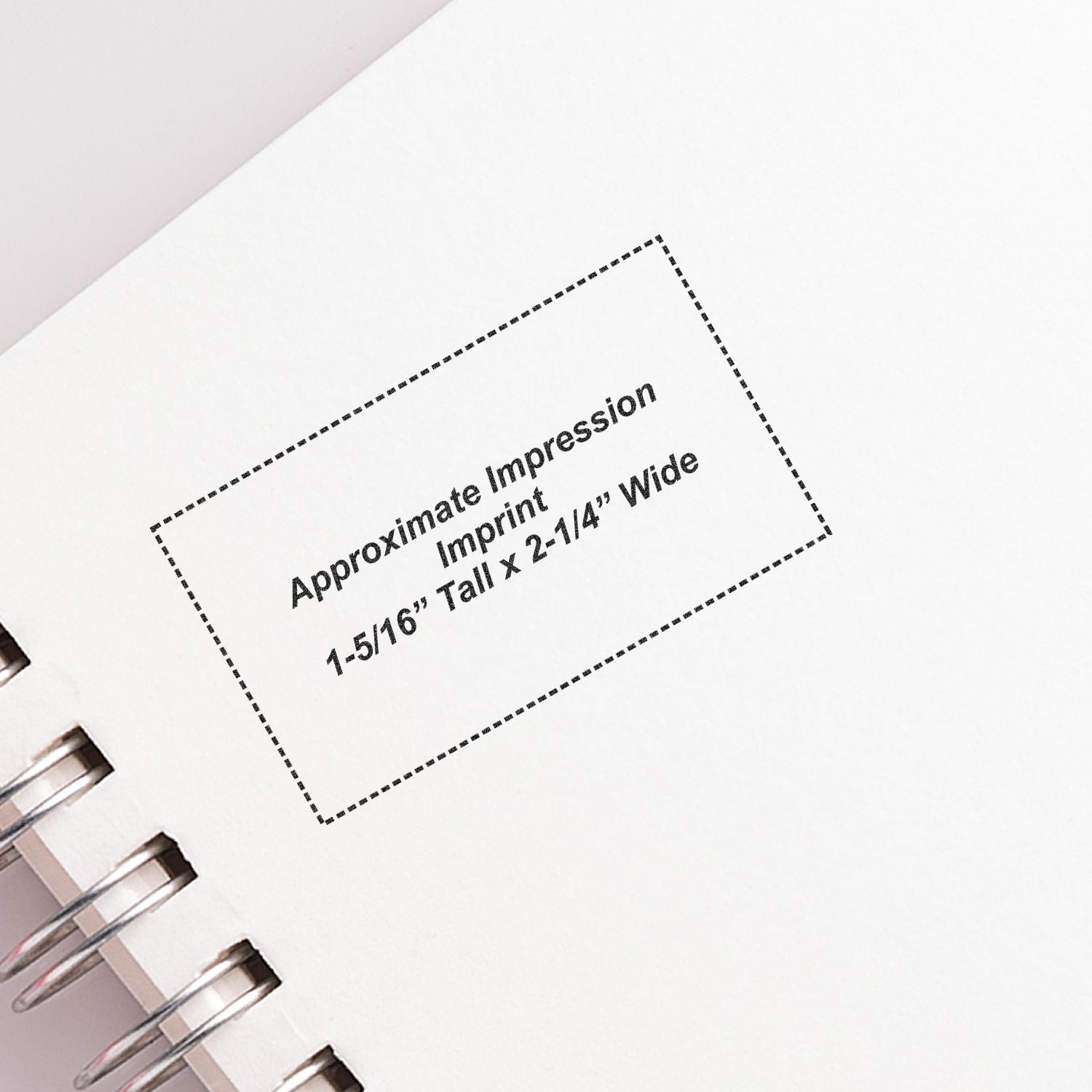 Custom Self Inking Stamp Trodat 5206 Size 1-5/16 x 2-1/4 imprint on a white notebook page with spiral binding.