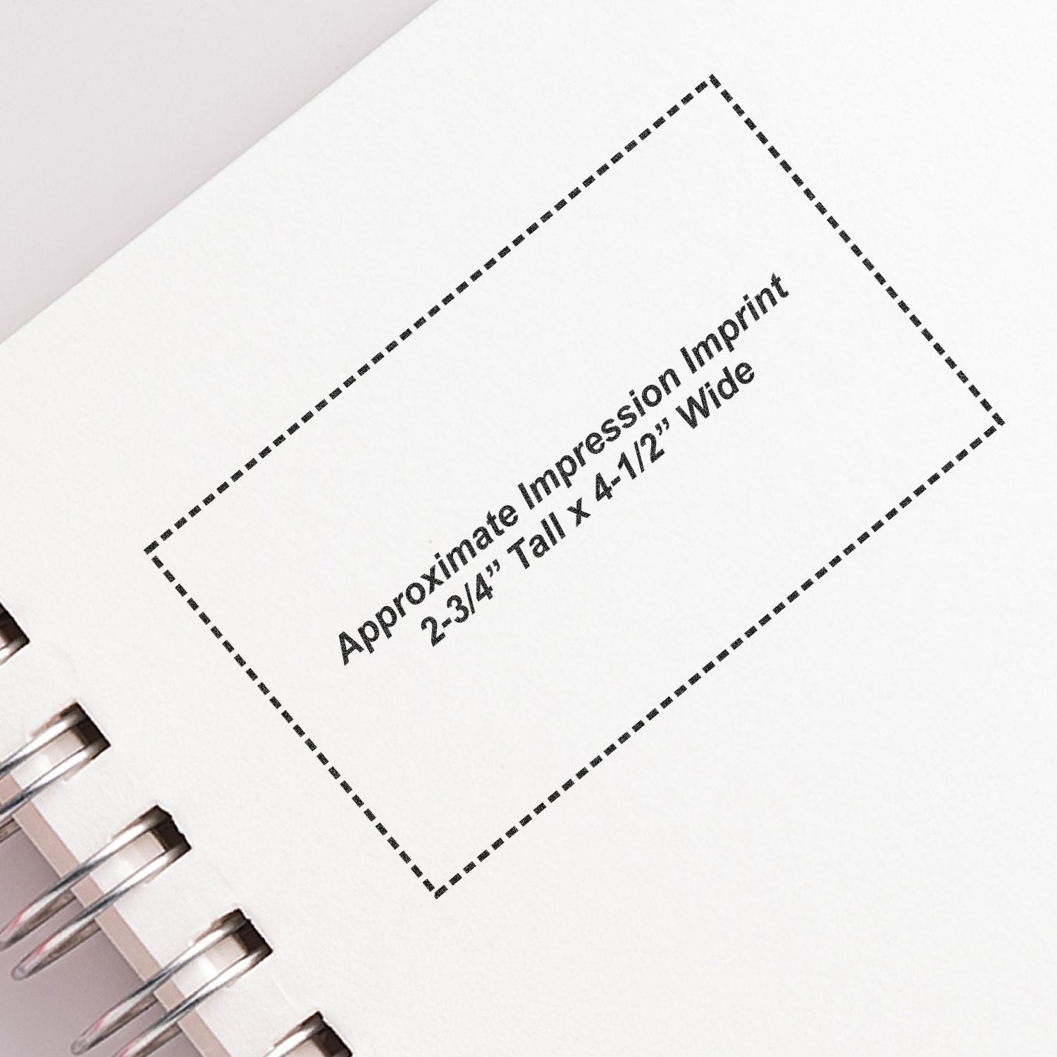 Custom Self Inking Stamp Trodat 5212 Size 2-3/4 x 4-1/2 imprint on a white notebook page with spiral binding.