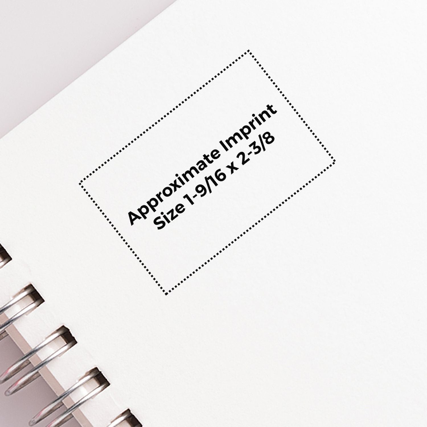 Custom Self Inking Stamp Trodat 5274 Size 1-9/16 x 2-3/8 imprint on white paper with spiral binding.