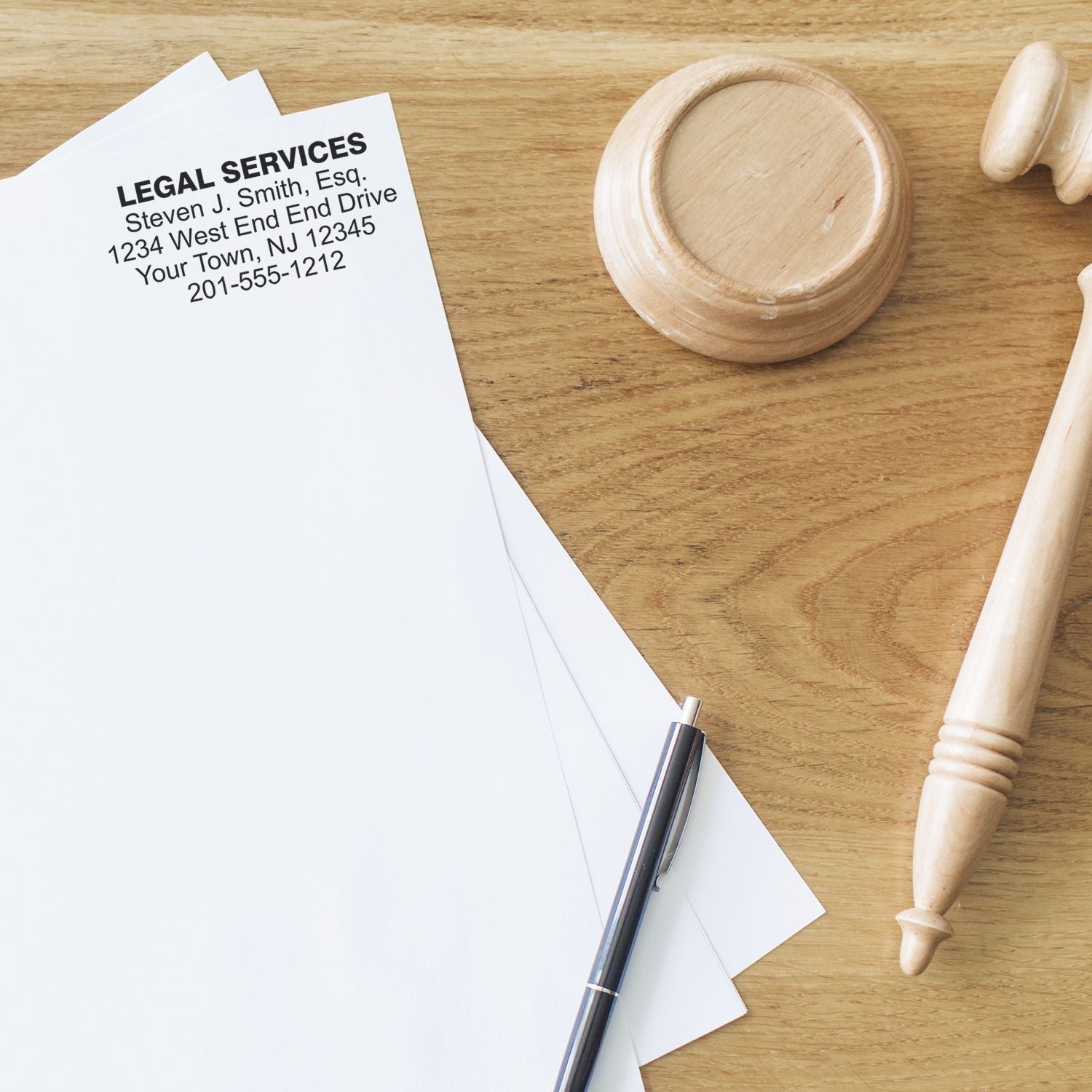 MaxLight XL2-700 Custom Pre-Inked Business Stamp 2-3/4-x 3-3/4 used on legal documents, with a pen and gavel on a wooden desk.
