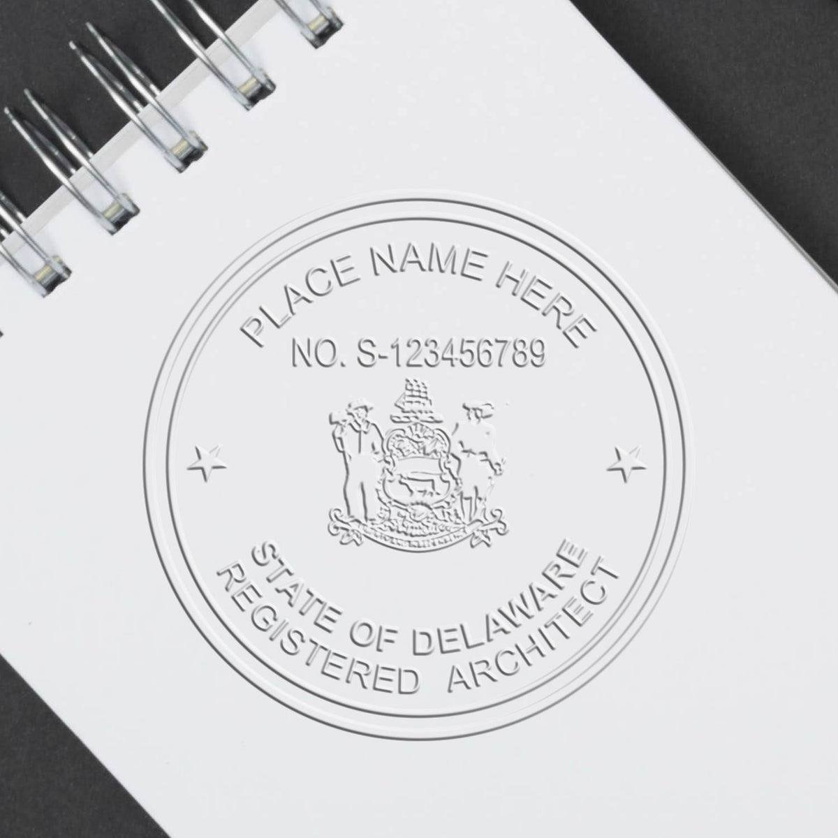 A stamped impression of the Handheld Delaware Architect Seal Embosser in this stylish lifestyle photo, setting the tone for a unique and personalized product.