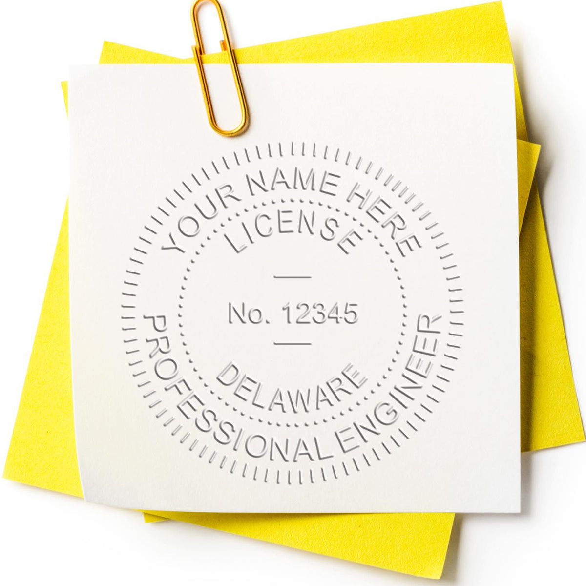 An in use photo of the Hybrid Delaware Engineer Seal showing a sample imprint on a cardstock