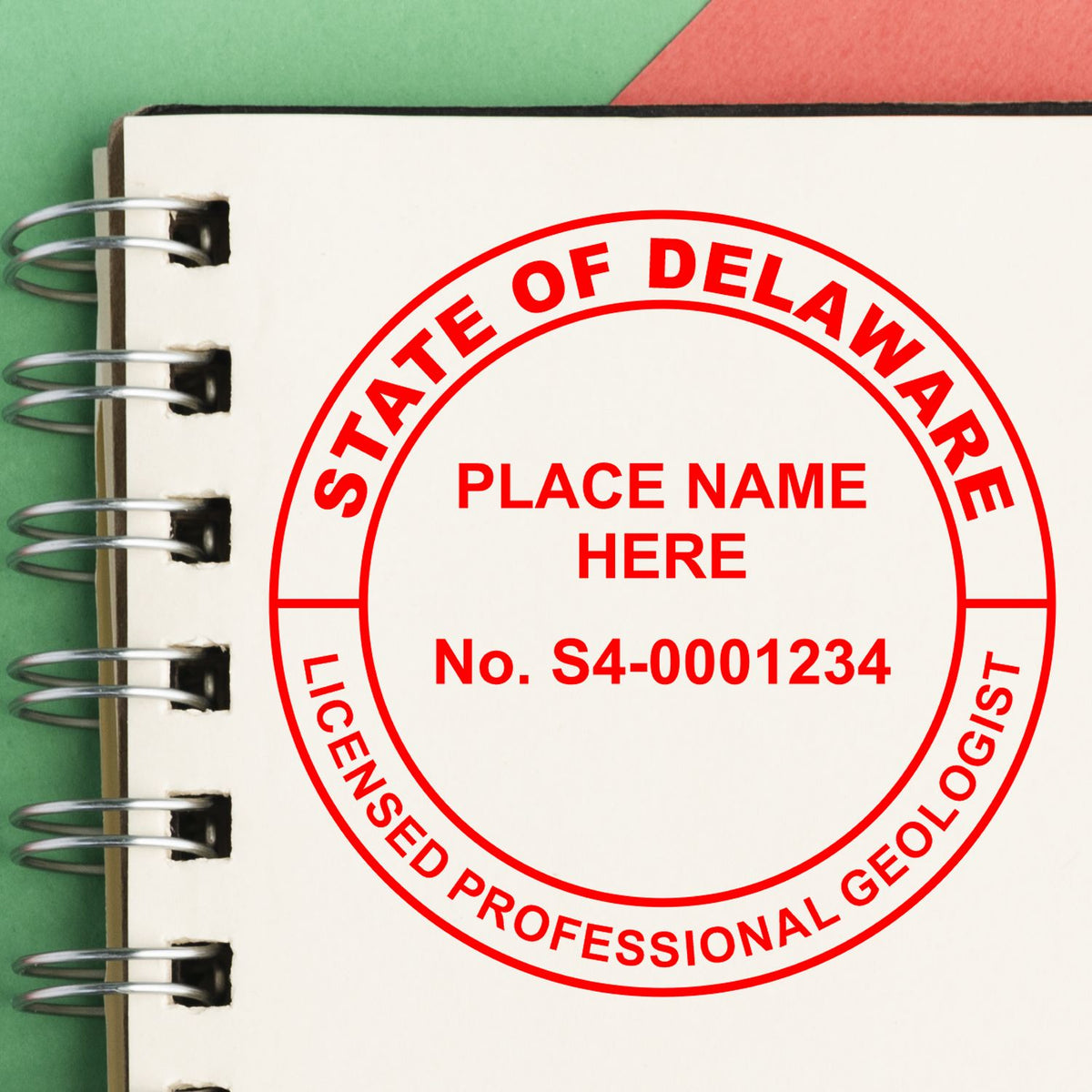 A lifestyle photo showing a stamped image of the Delaware Professional Geologist Seal Stamp on a piece of paper