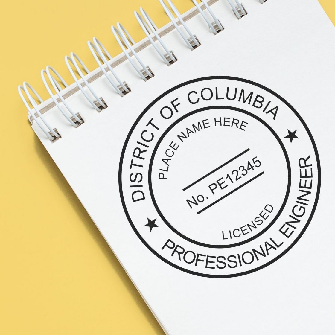 A lifestyle photo showing a stamped image of the Slim Pre-Inked District of Columbia Professional Engineer Seal Stamp on a piece of paper