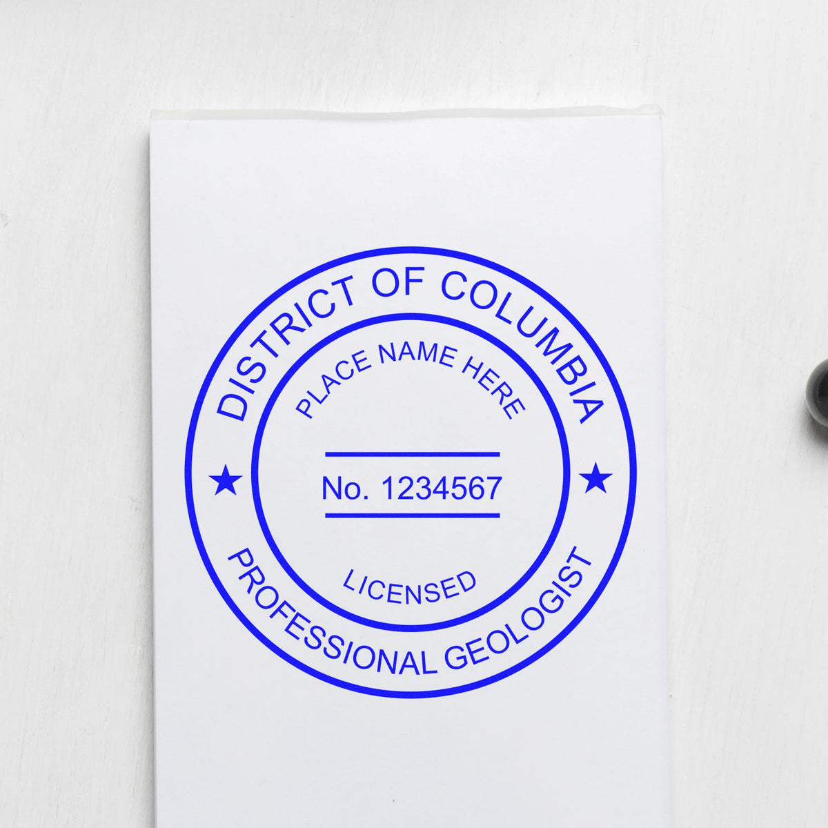 An alternative view of the Self-Inking District of Columbia Geologist Stamp stamped on a sheet of paper showing the image in use