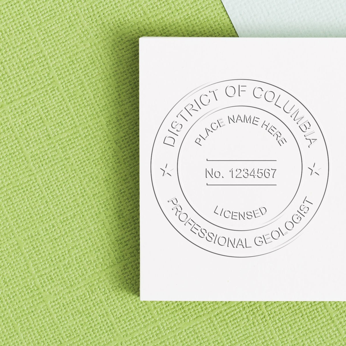 A stamped imprint of the State of District of Columbia Extended Long Reach Geologist Seal in this stylish lifestyle photo, setting the tone for a unique and personalized product.