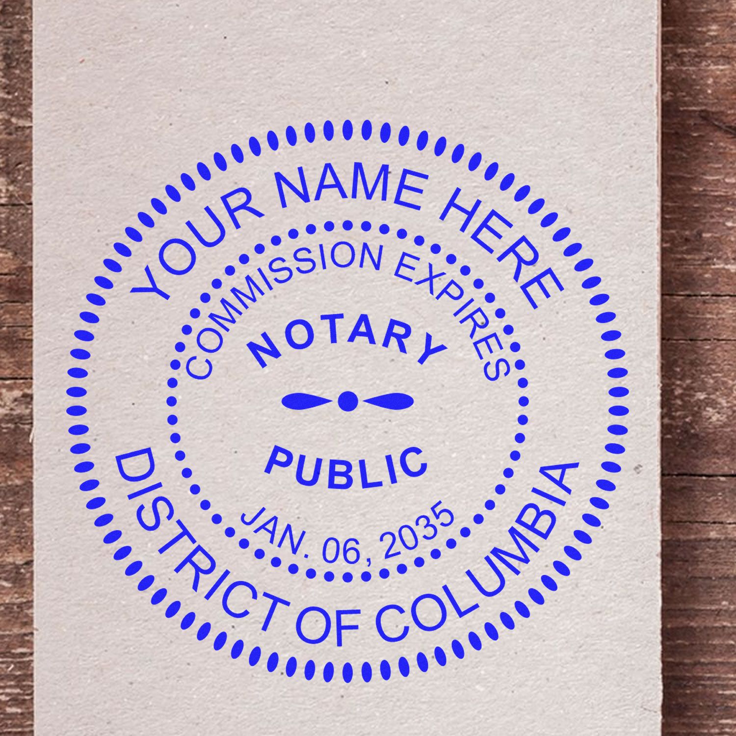 An alternative view of the Heavy-Duty Round District of Columbia Notary Stamp stamped on a sheet of paper showing the image in use