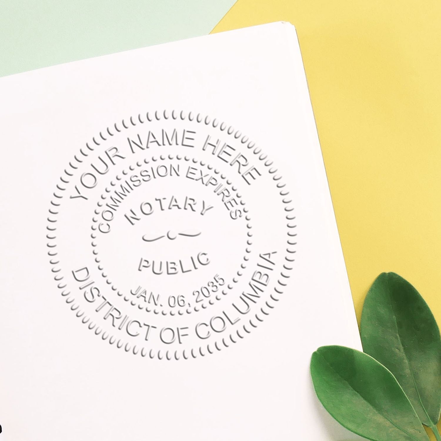 A stamped impression of the District of Columbia Handheld Notary Seal Embosser in this stylish lifestyle photo, setting the tone for a unique and personalized product.