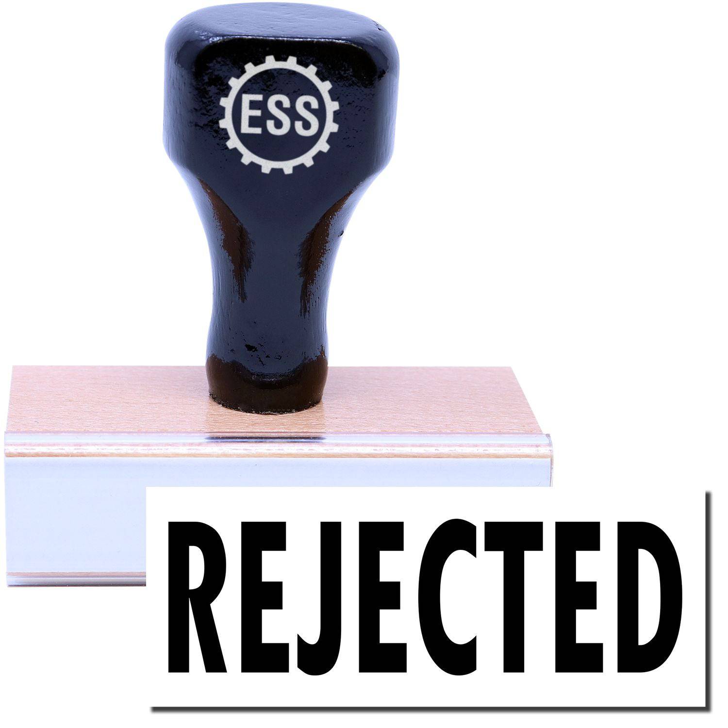 A stock office rubber stamp with a stamped image showing how the text REJECTED in a large font is displayed after stamping.