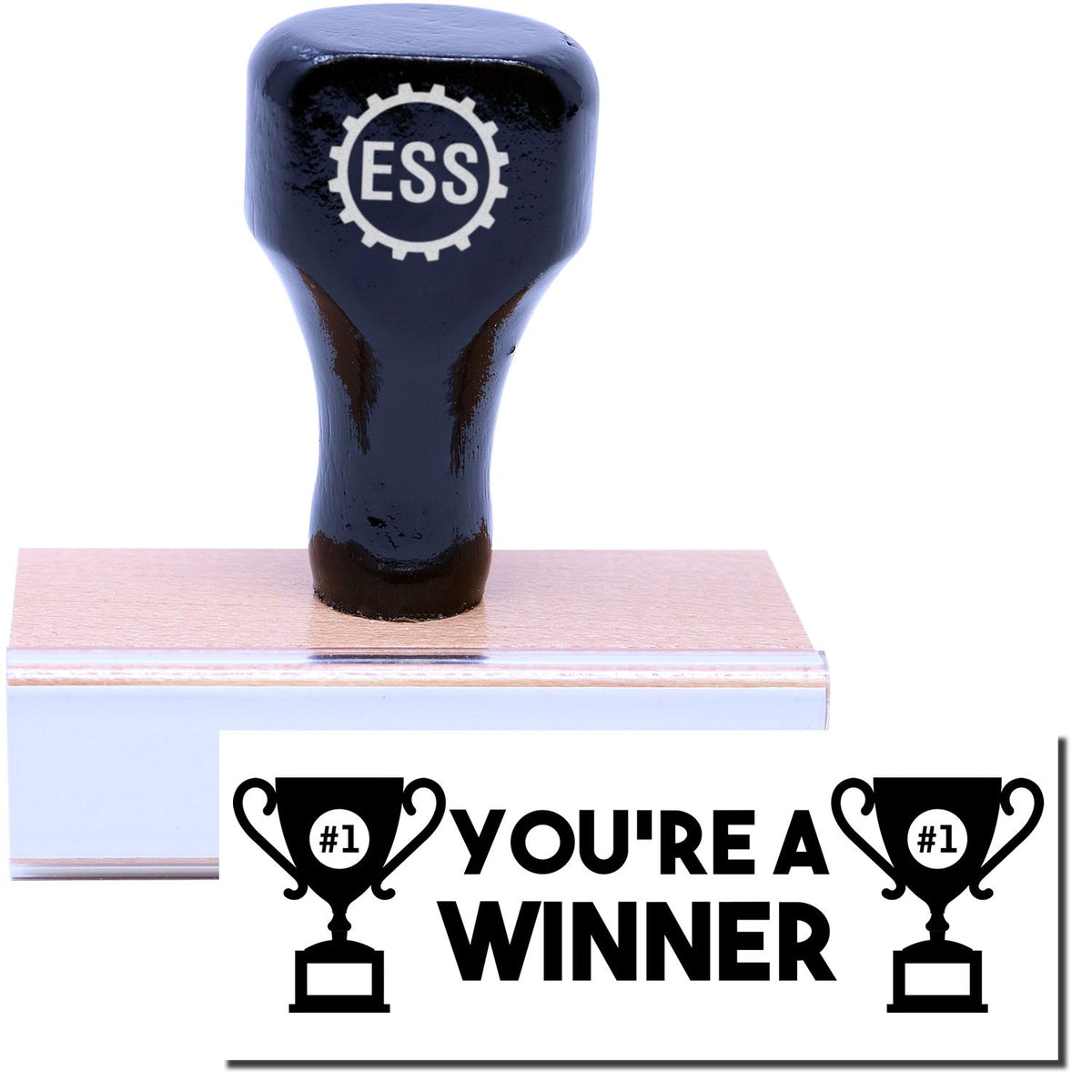 A stock office rubber stamp with a stamped image showing how the text &quot;YOU&#39;RE A WINNER&quot; in bold font and images of a trophy with #1 inside is displayed after stamping.