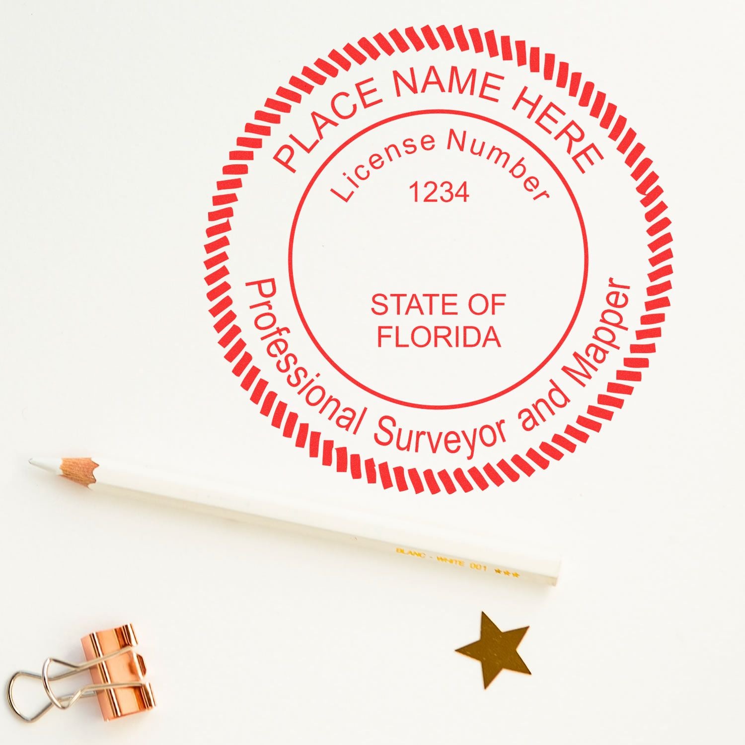 Premium MaxLight Pre-Inked Florida Surveyors Stamp in red ink on white paper, with a pencil, gold star, and copper clip nearby.