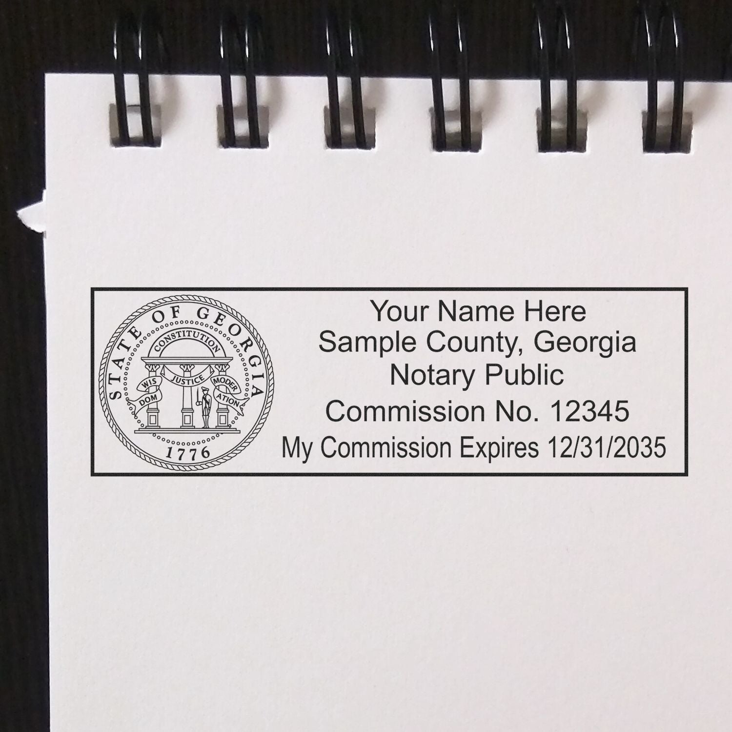 The main image for the Heavy-Duty Georgia Rectangular Notary Stamp depicting a sample of the imprint and electronic files