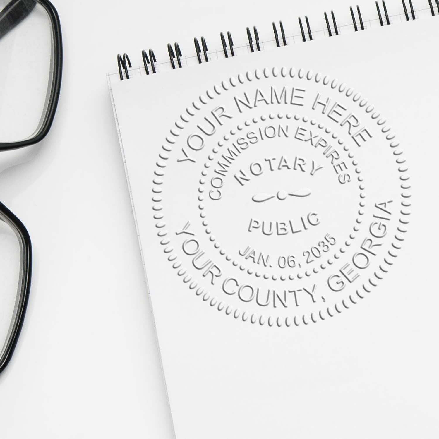 The Georgia Handheld Notary Seal Embosser stamp impression comes to life with a crisp, detailed photo on paper - showcasing true professional quality.