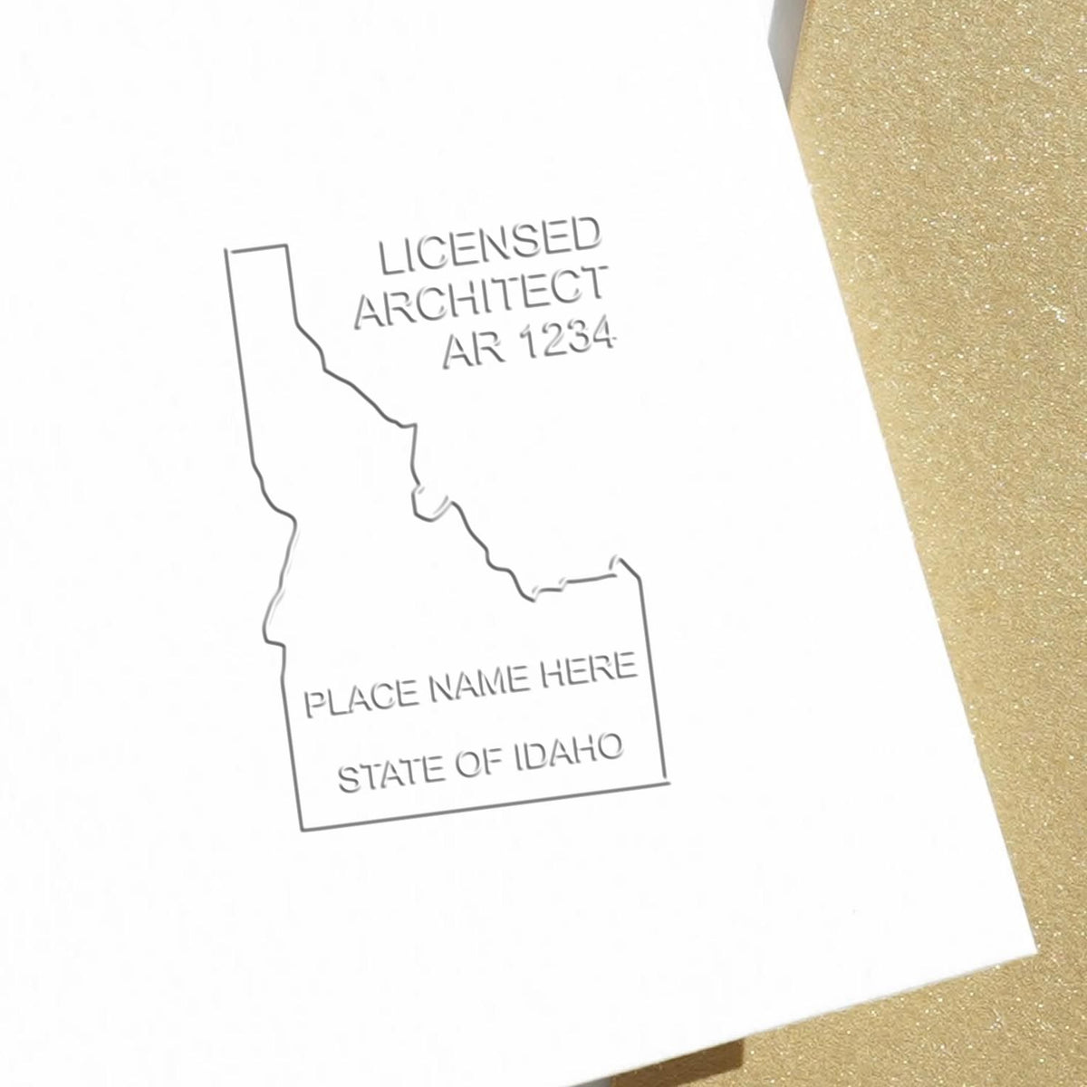 An in use photo of the Hybrid Idaho Architect Seal showing a sample imprint on a cardstock