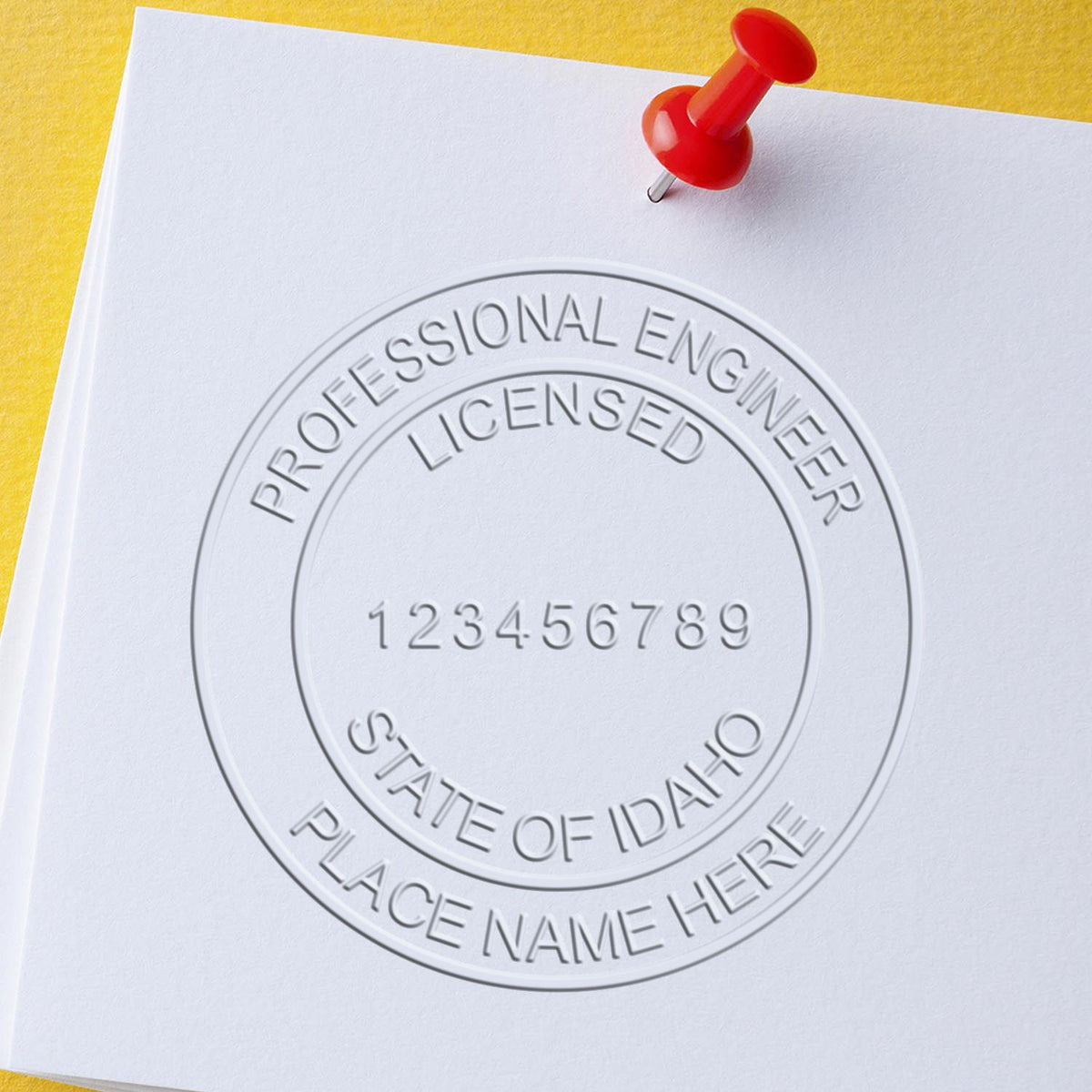 An alternative view of the Heavy Duty Cast Iron Idaho Engineer Seal Embosser stamped on a sheet of paper showing the image in use