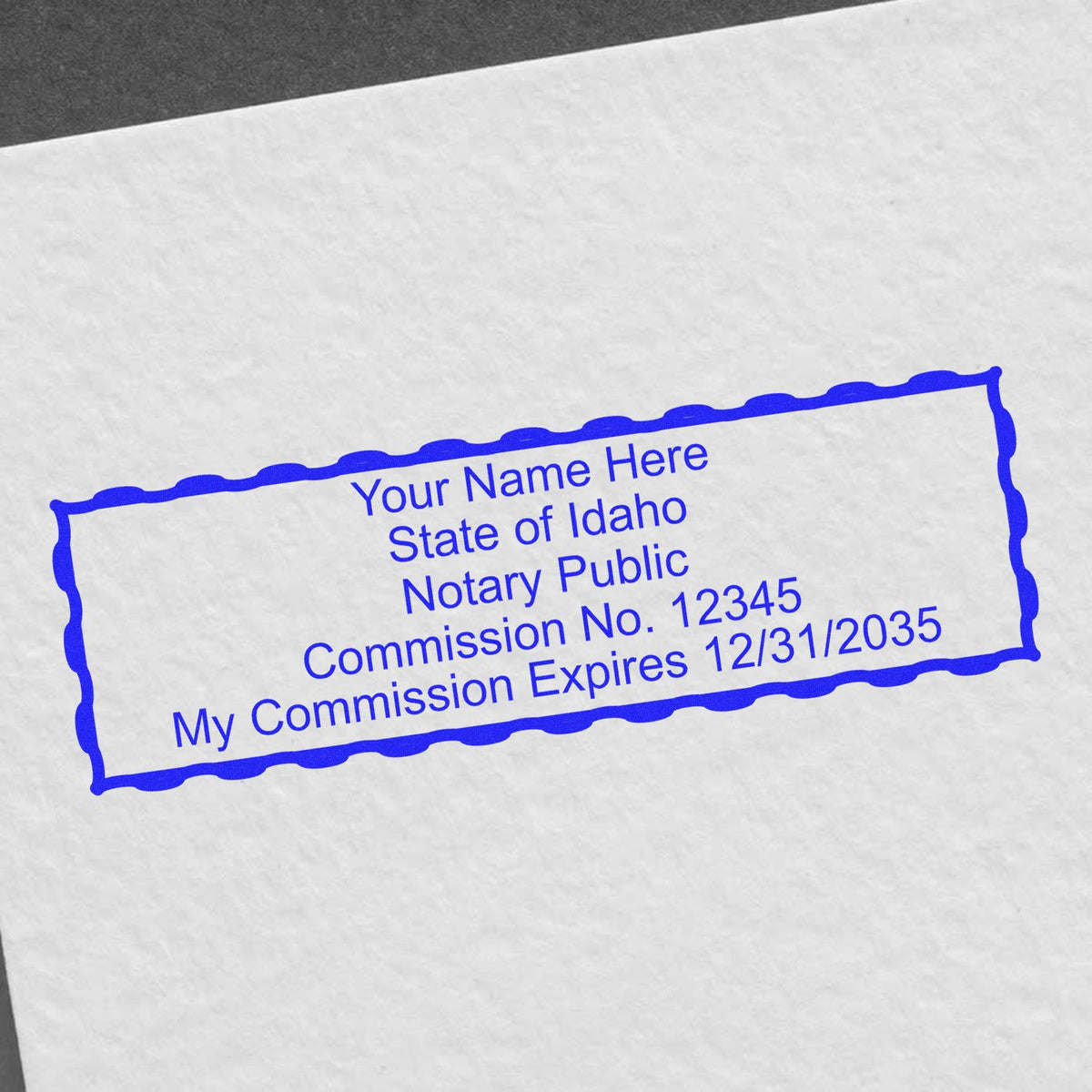 An alternative view of the Super Slim Idaho Notary Public Stamp stamped on a sheet of paper showing the image in use