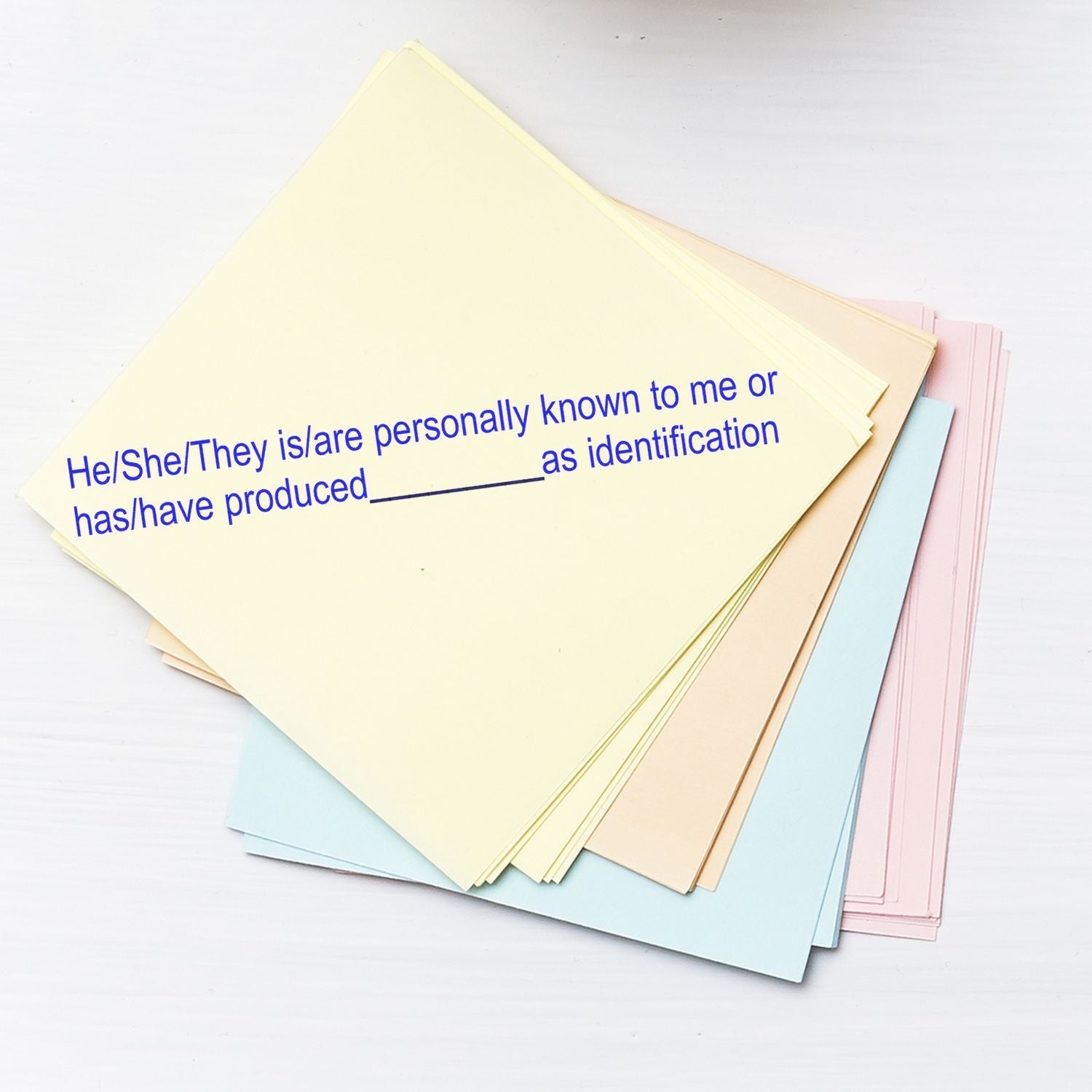 MaxLight Pre-Inked Stamp Identification Notary Stamp in use on a stack of pastel-colored papers with text for identification purposes.