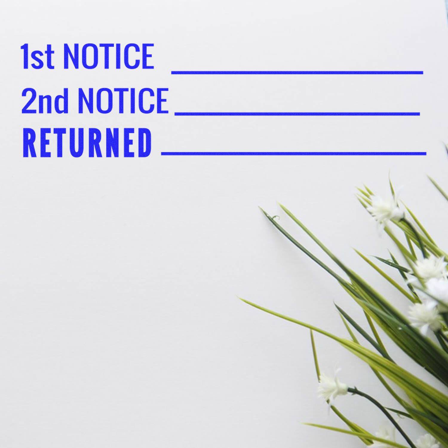Large Pre-Inked 1st 2nd Notice Returned Stamp on white paper with blue text, next to green and white flowers.