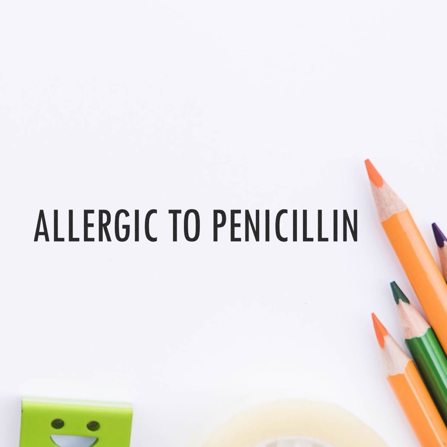 Allergic To Penicillin Self-Inking Stamp used on white paper, surrounded by colorful pencils and a green eraser.