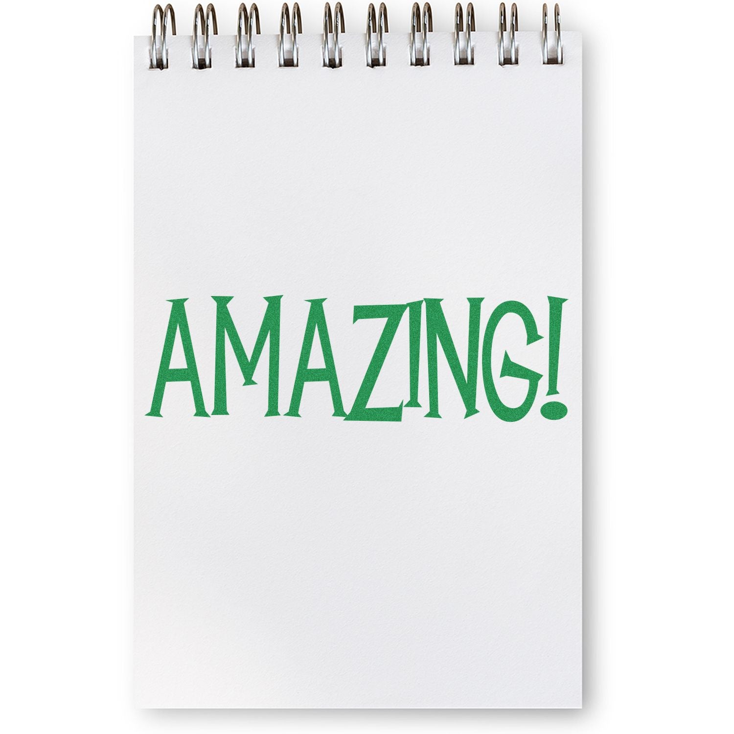 Notepad with spiral binding displaying the word "AMAZING!" in green, stamped using the Amazing Rubber Stamp.