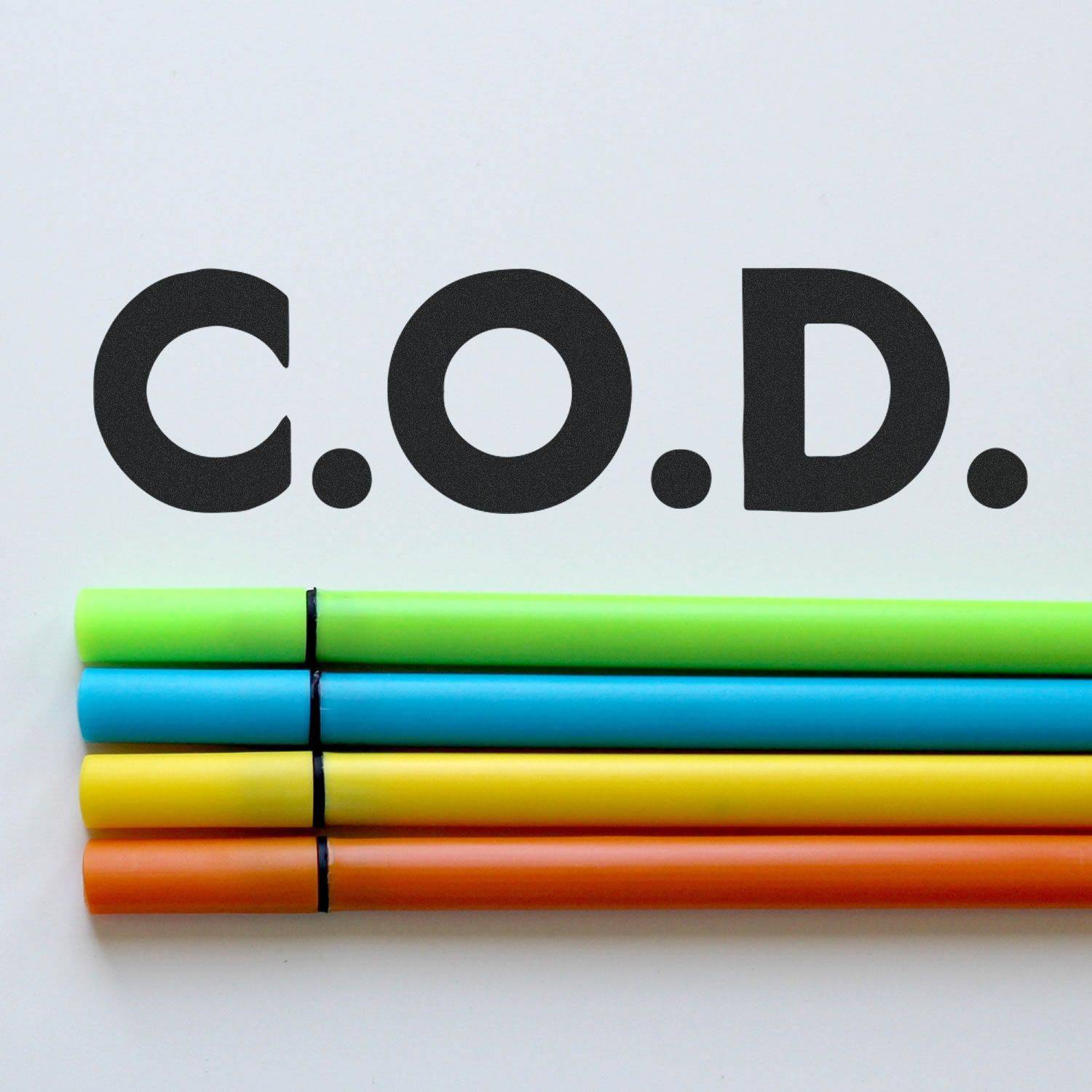 Large Self Inking Bold C.O.D. Stamp in use, displaying C.O.D. in bold black letters on a white background with colorful markers below.
