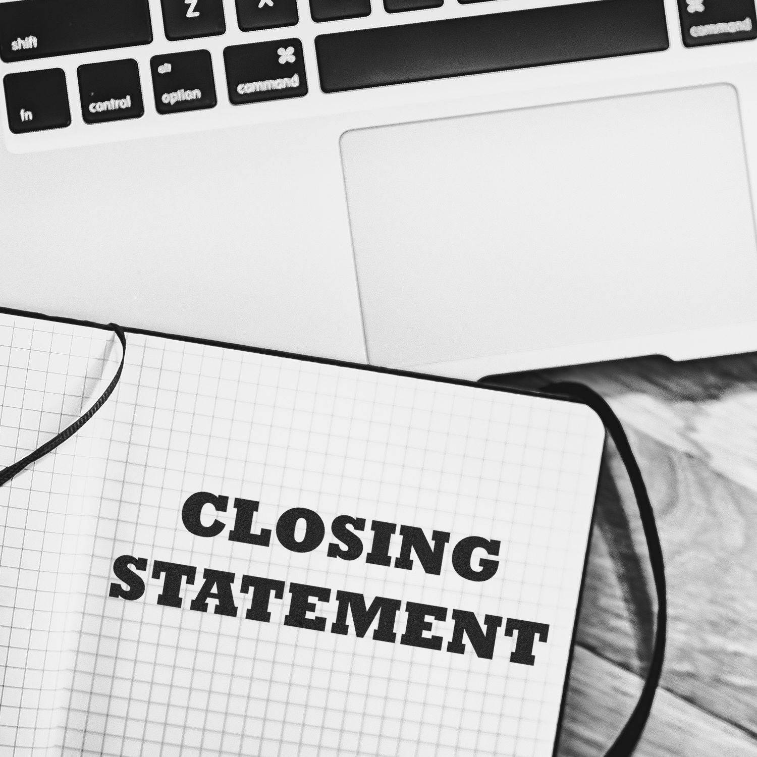 Large Self Inking Closing Statement Stamp used on a notebook with the words 'CLOSING STATEMENT' stamped in bold black ink, placed next to a laptop keyboard.