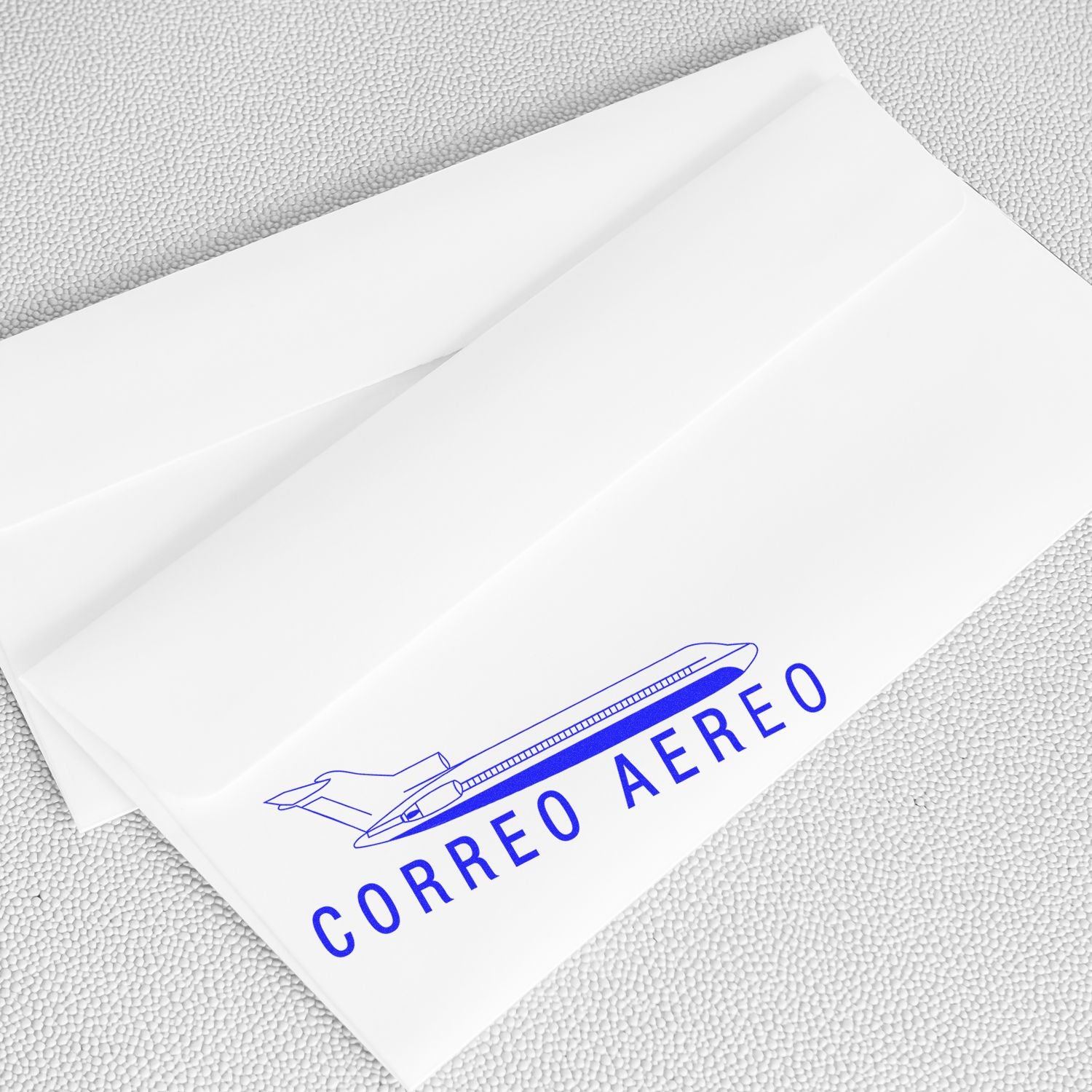 White envelopes stamped with the Large Correo Aero Rubber Stamp, featuring a blue airplane and text CORREO AEREO on a textured surface.