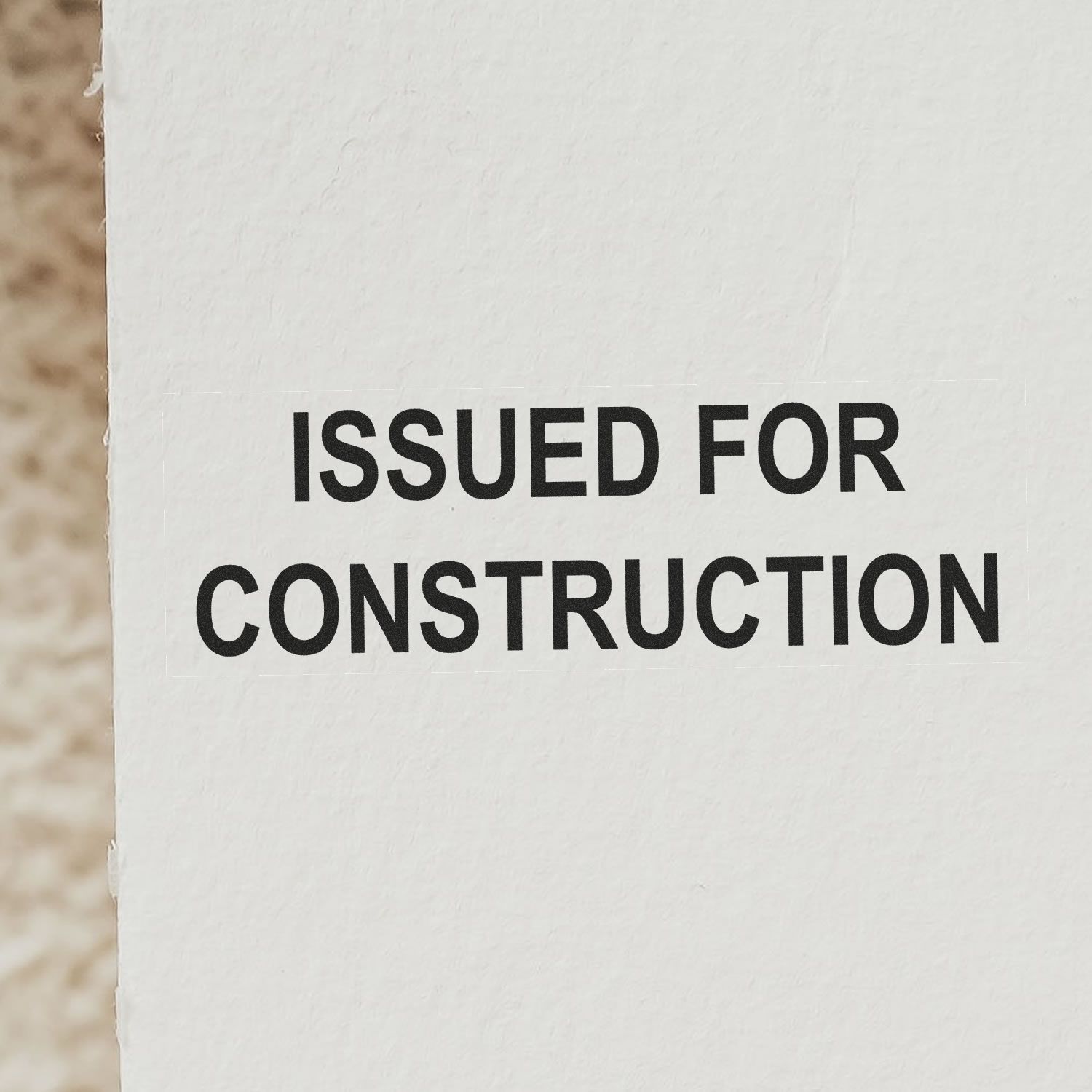 Close-up of a document stamped with 'ISSUED FOR CONSTRUCTION' using a Self Inking Issued for Construction Stamp.