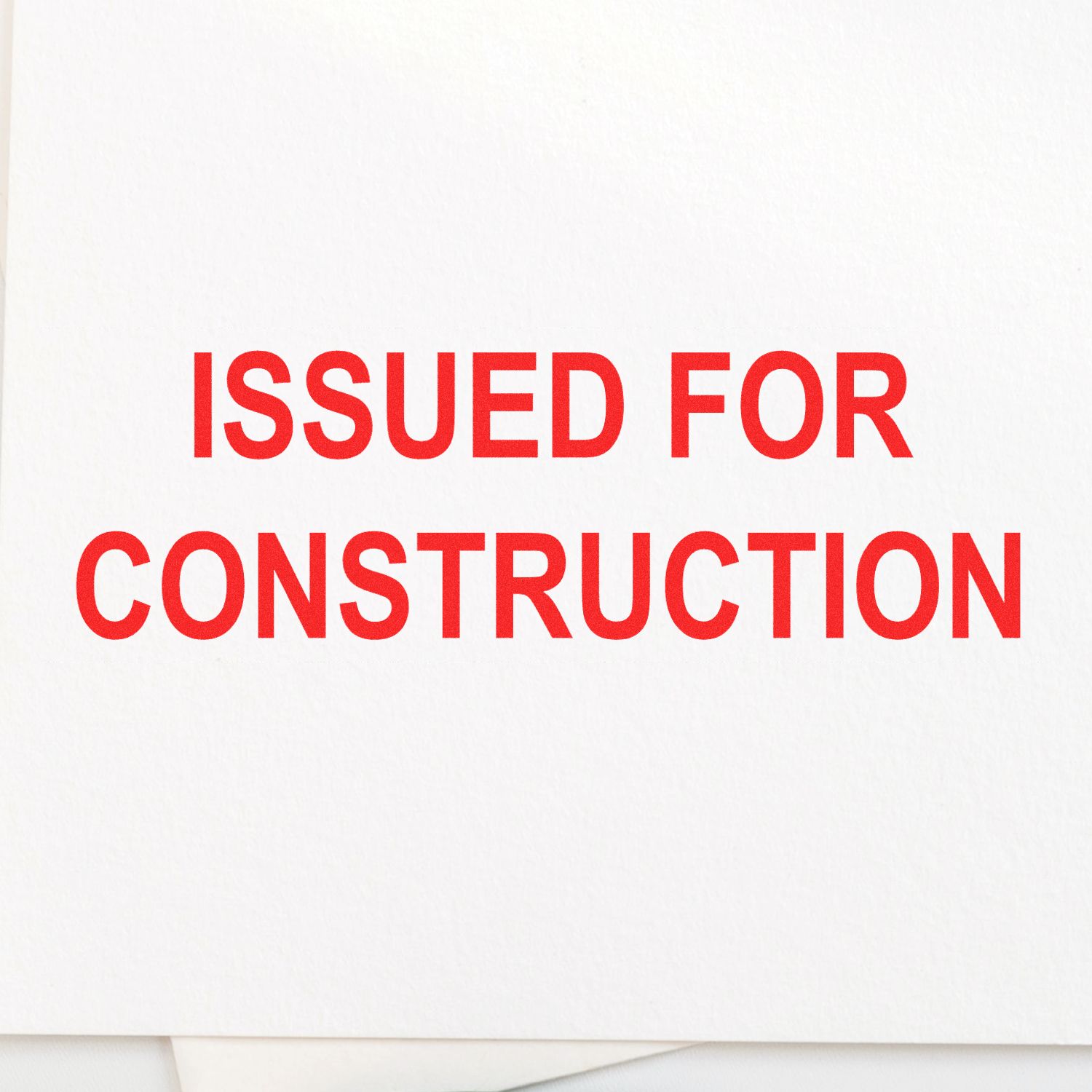 Self Inking Issued for Construction Stamp imprint in bold red letters on white paper, indicating approval for construction projects.
