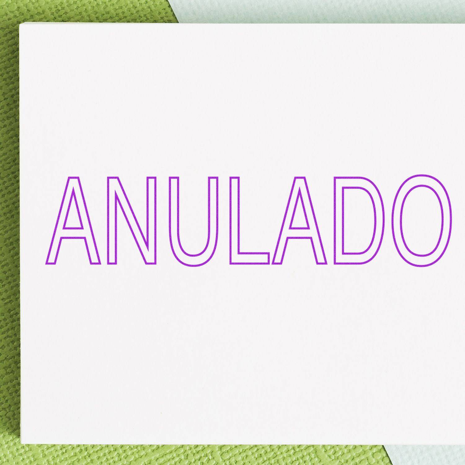 Large Pre-Inked Outline Anulado Stamp in use, imprinting red 'Anulado' text on a document, ideal for office use.