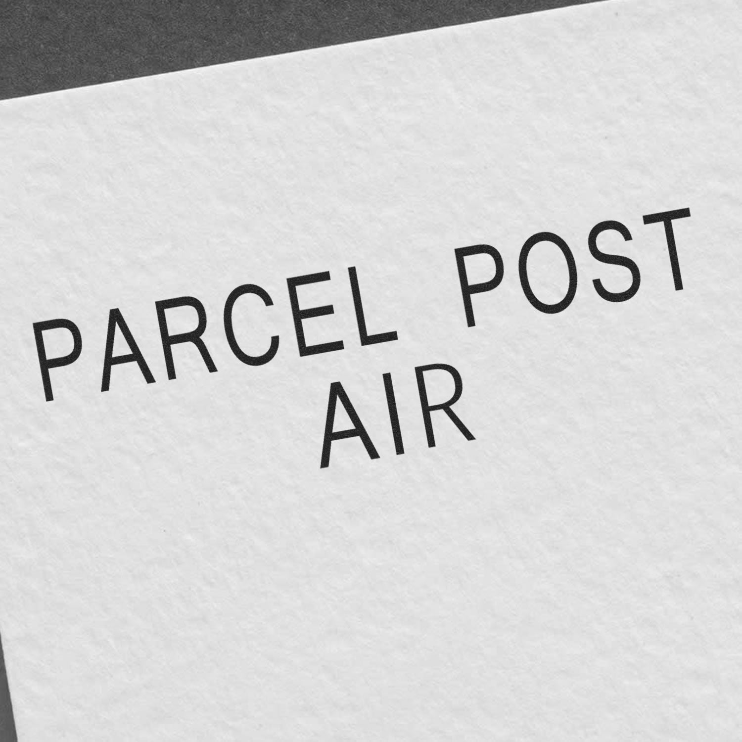 Close-up of a stamped paper with the text 'PARCEL POST AIR' using the Large Self Inking Parcel Post Air Stamp.