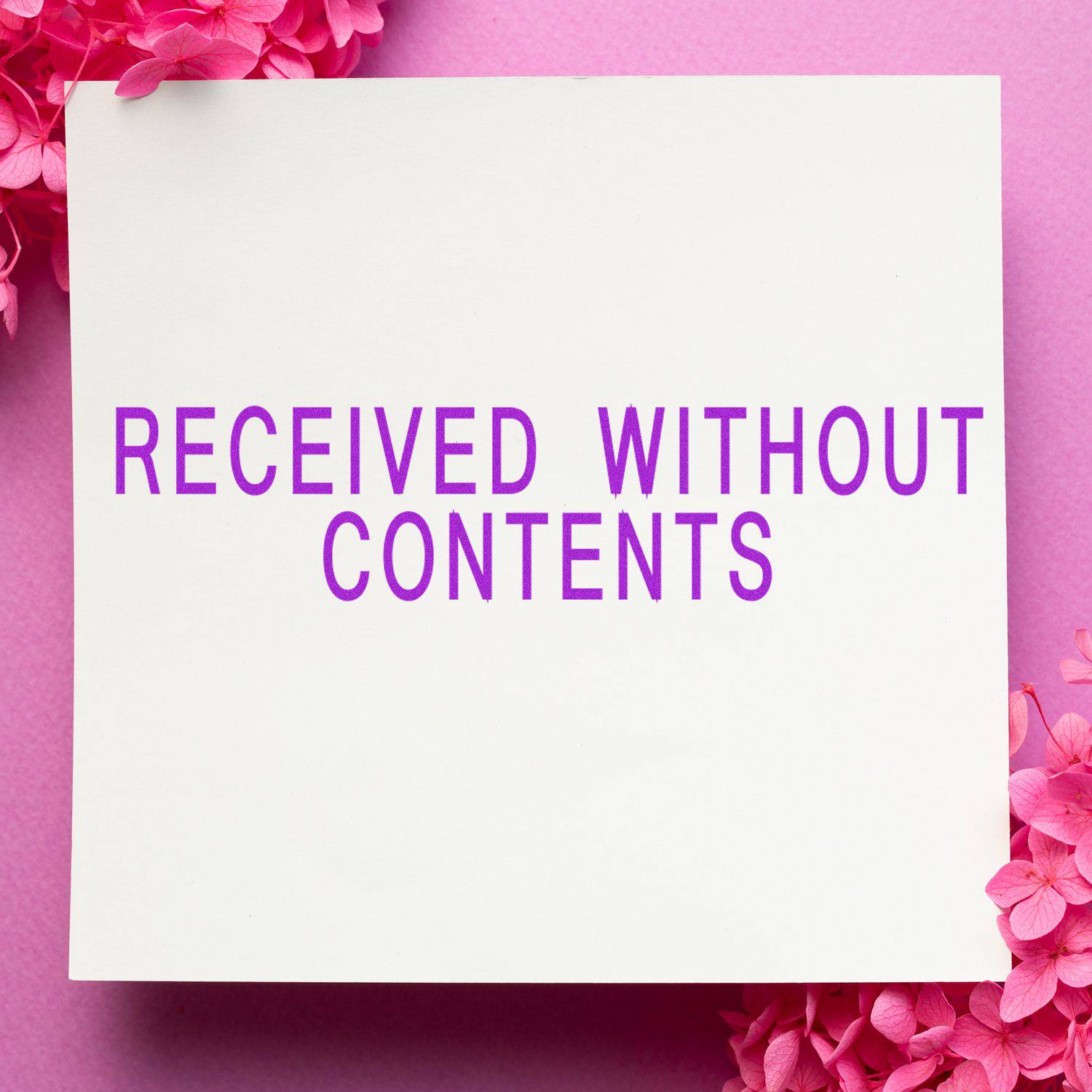 Large Received Without Contents Rubber Stamp used on a white paper with pink flowers on a pink background.