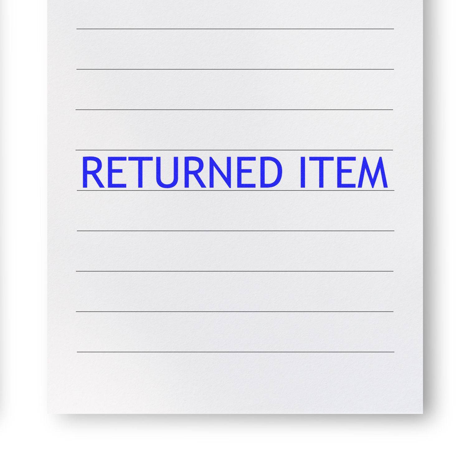 Paper stamped with RETURNED ITEM in blue ink using the Large Returned Item Rubber Stamp.