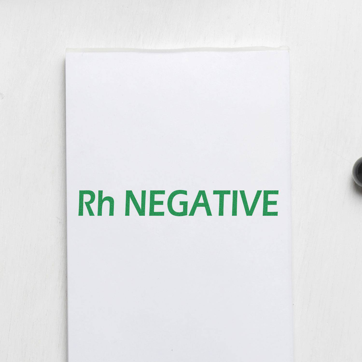 Large Rh Negative Rubber Stamp imprint in green ink on white paper, showcasing clear and bold text.