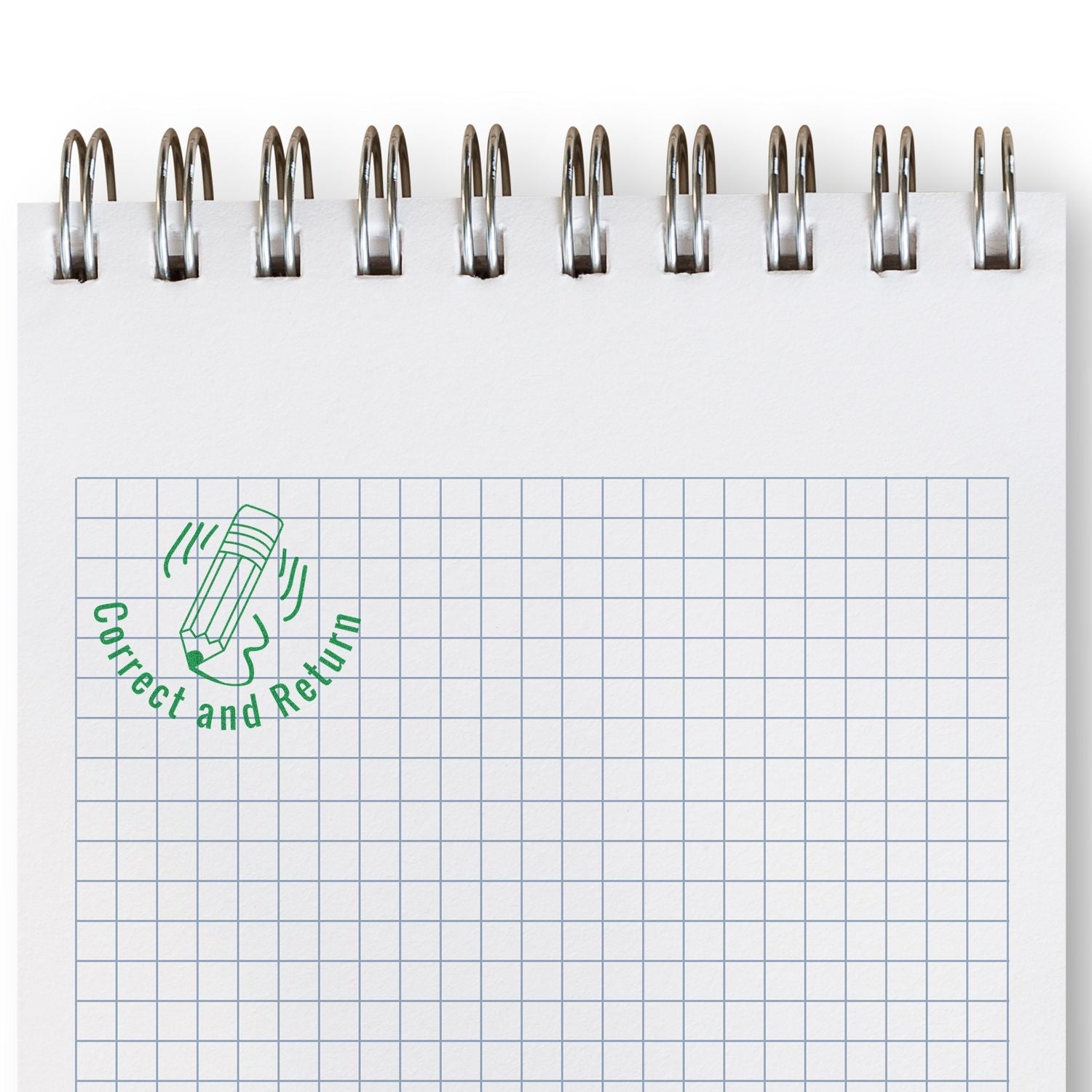 A notebook with a grid pattern featuring a green Correct and Return mark from the Self Inking Round Shocked Smiley Stamp in the top left corner.