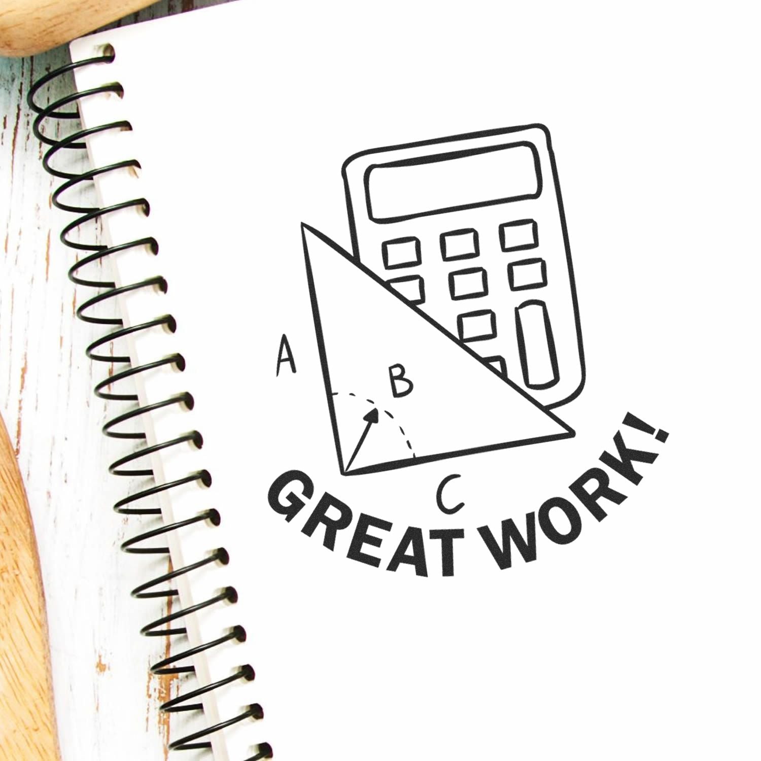 Self Inking Round Great Work with Calculator Stamp imprint on a spiral notebook, featuring a calculator and geometric shapes.