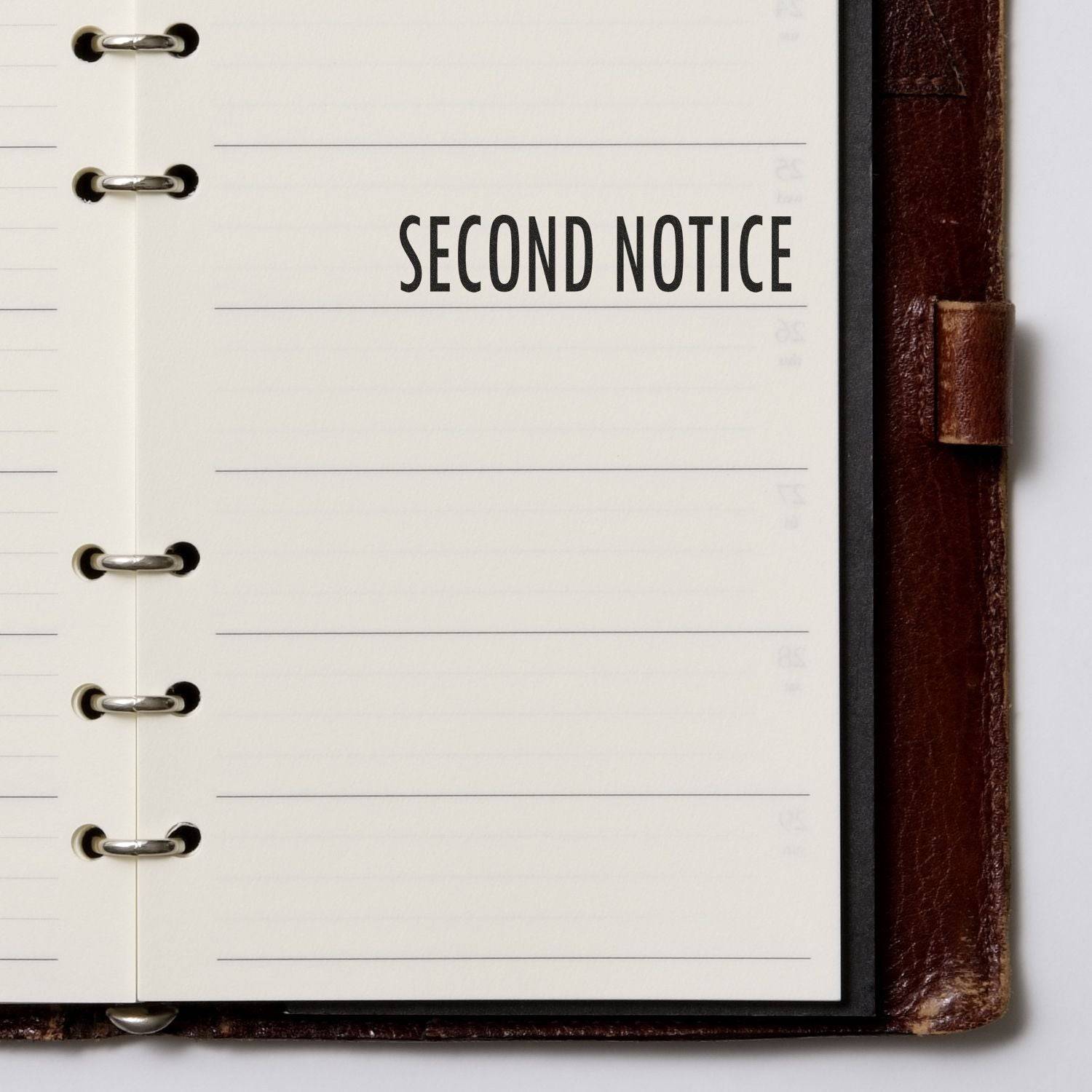 Large Pre-Inked Second Notice Stamp used on a lined page in a leather-bound planner, displaying the text SECOND NOTICE in bold letters.
