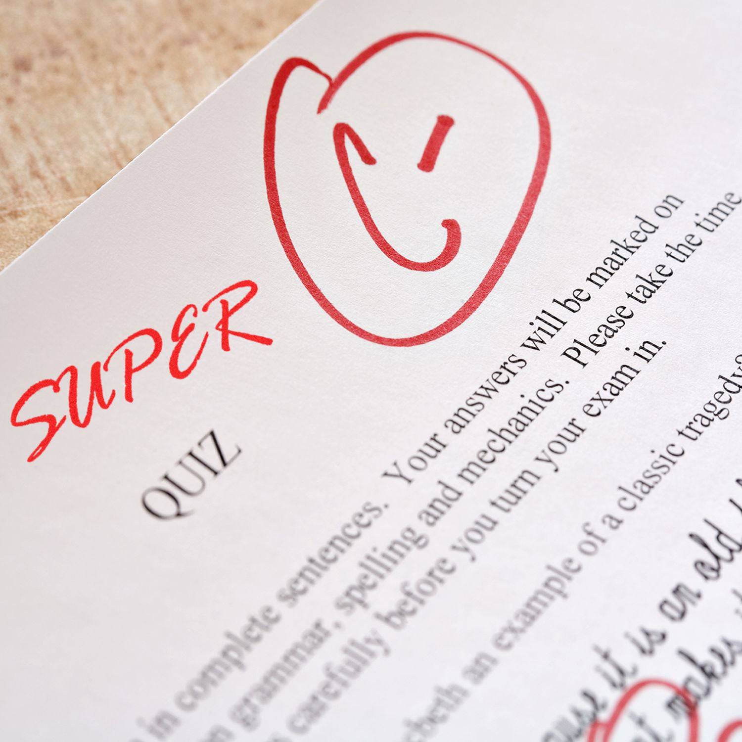 A paper marked with a red C and the word SUPER using the Large Pre-Inked Super Stamp, indicating a graded quiz.
