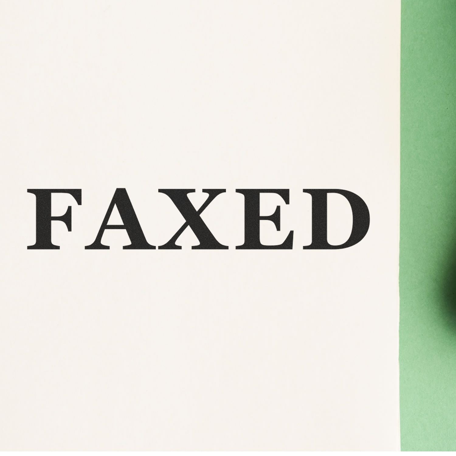 Large Times Faxed Rubber Stamp imprinting the word 'FAXED' in bold black letters on a white paper with a green background."