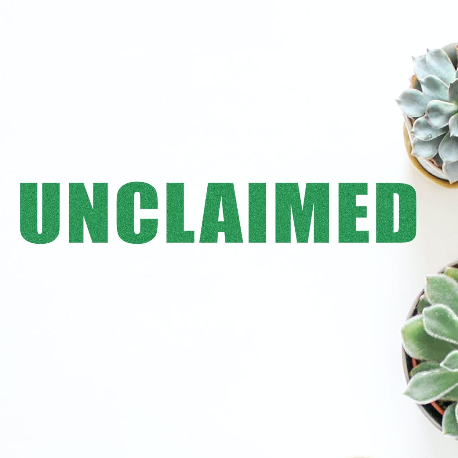 Green UNCLAIMED text stamped on white paper using a Self Inking Unclaimed Stamp, with succulents in the corners.