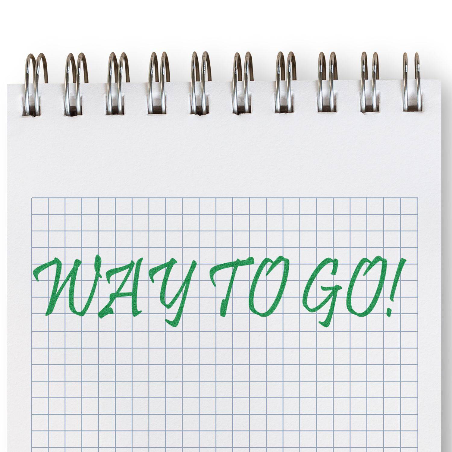 Large Pre-Inked Way To Go Stamp in green ink on a spiral-bound notebook with graph paper.
